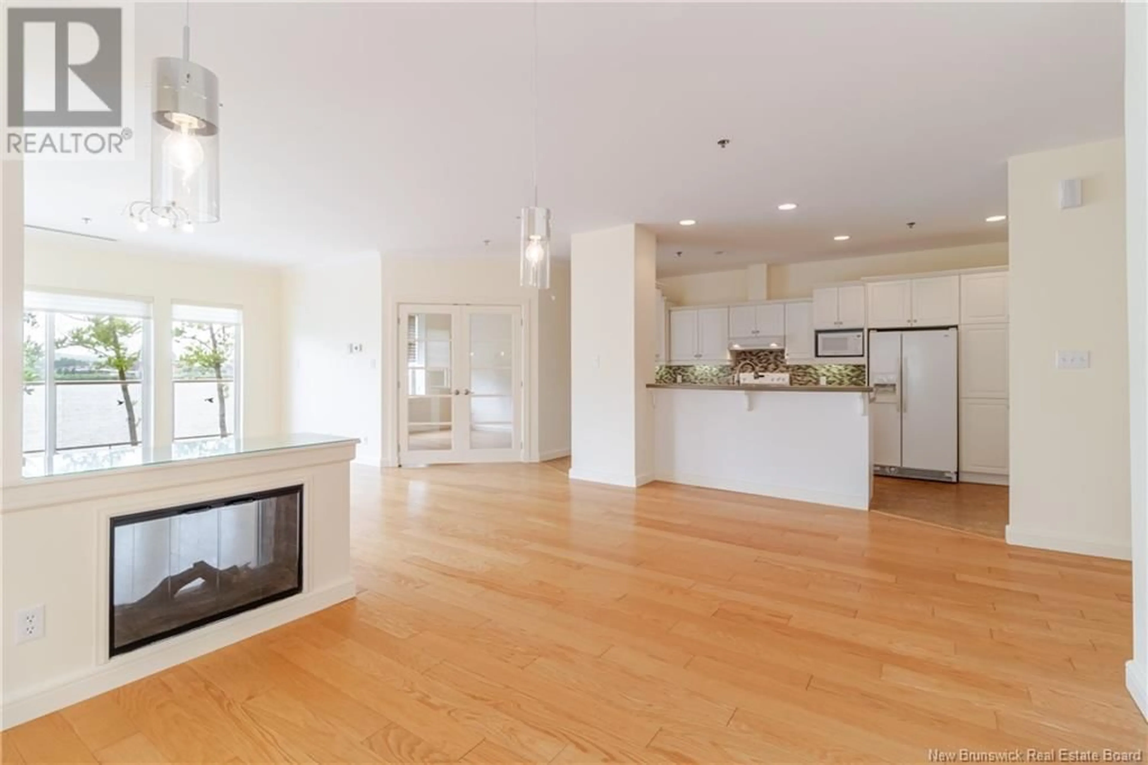 Open concept kitchen, wood/laminate floor for 101 - 1 SOUTHVIEW LANE LANE, Fredericton New Brunswick E3A5V3