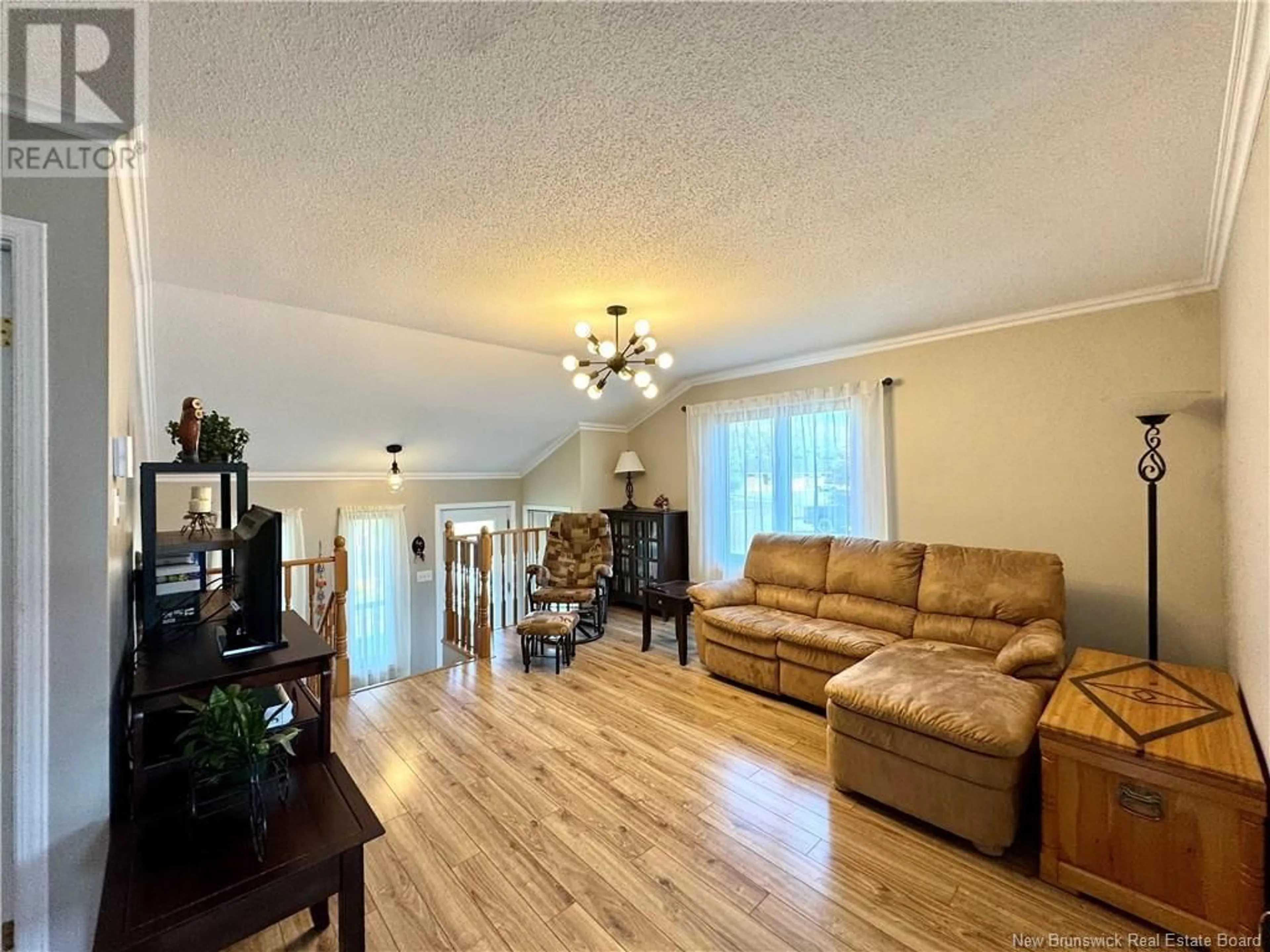 Living room with furniture, wood/laminate floor for 49 RUE LEBEL STREET, Edmundston New Brunswick E3V3Y3