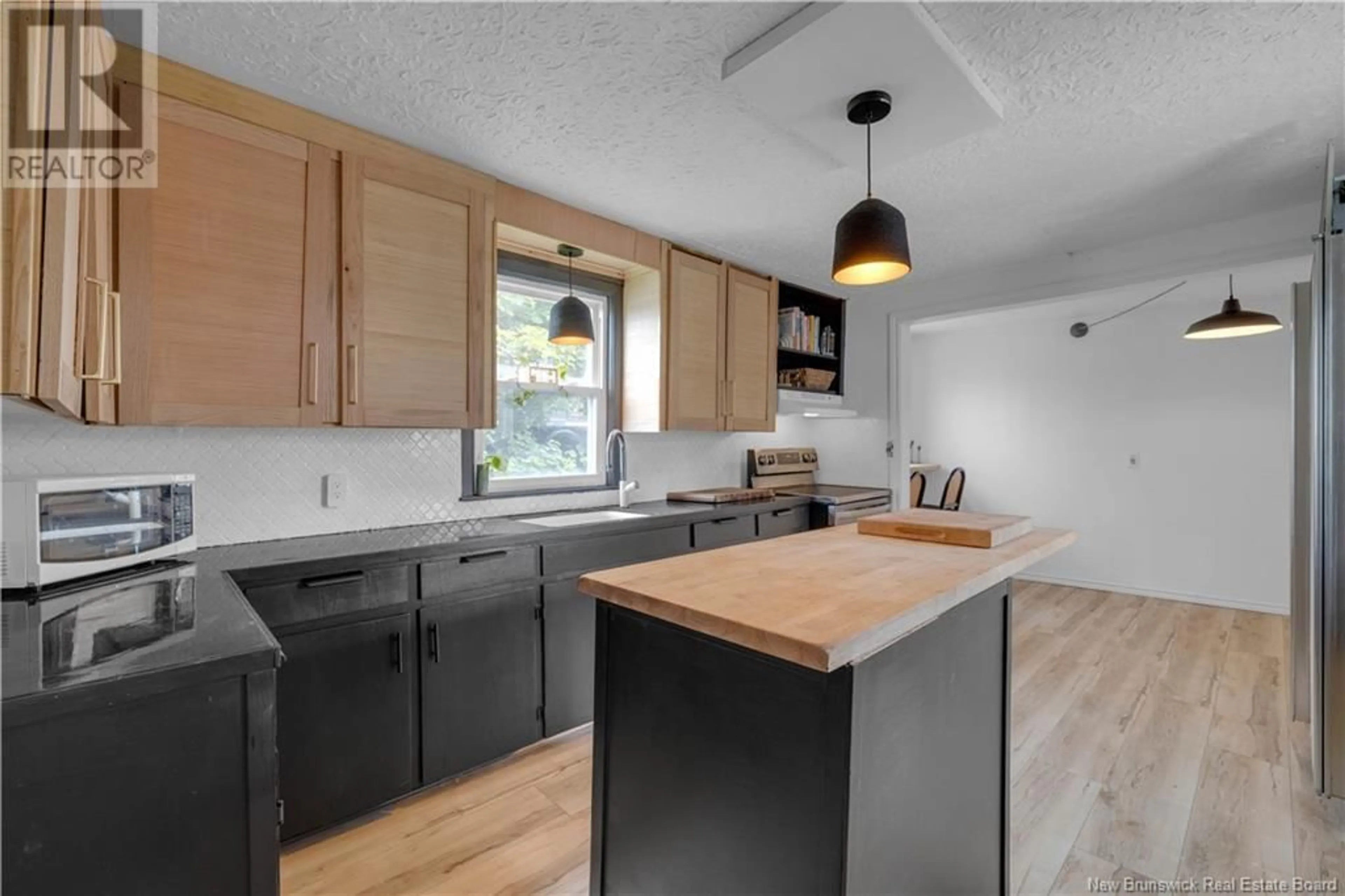 Open concept kitchen, wood/laminate floor for 244 RODNEY STREET, Saint John New Brunswick E2M1X6