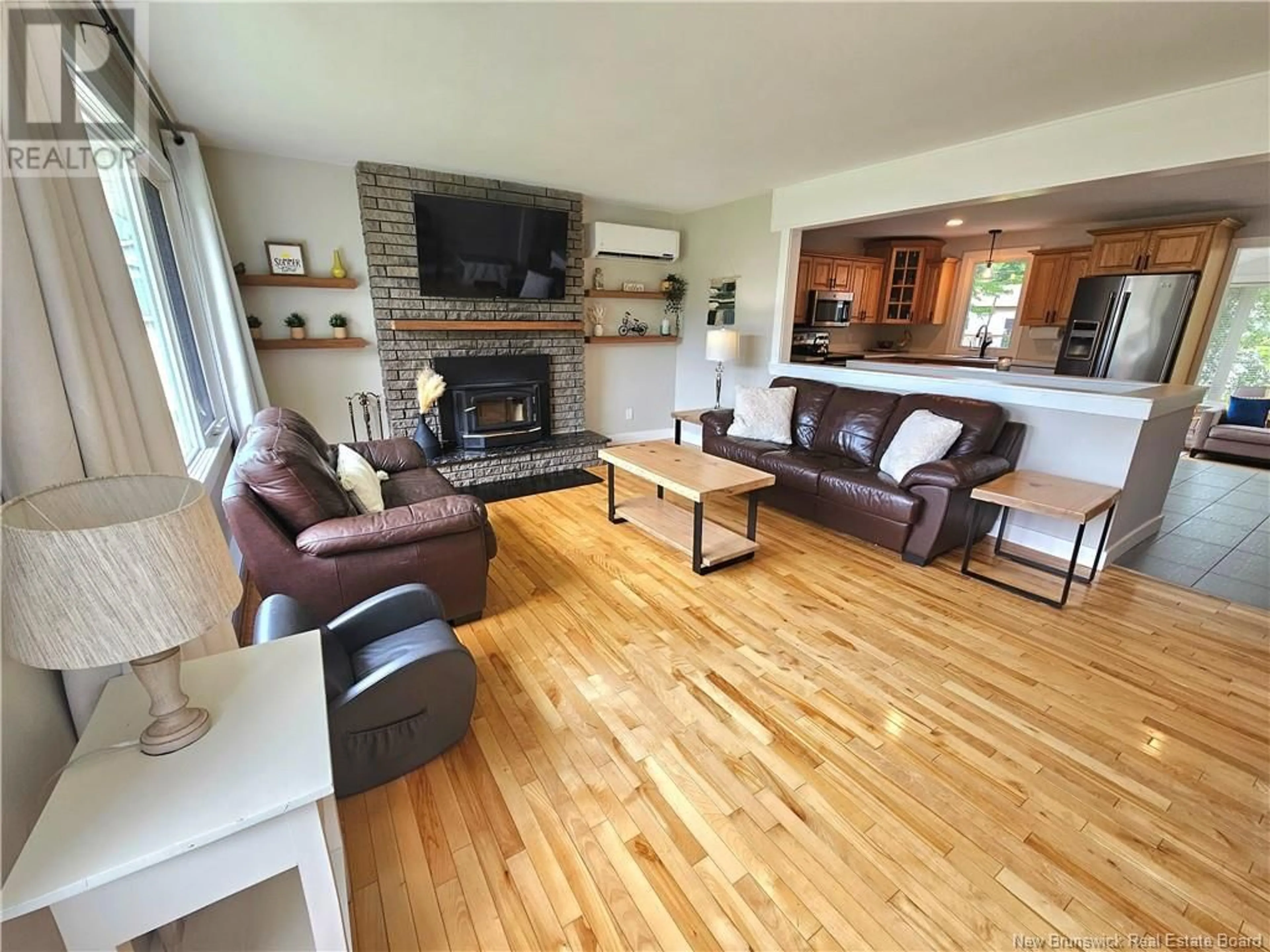 Living room with furniture, wood/laminate floor for 424 CHARTERSVILLE ROAD, Dieppe New Brunswick E1A5A1