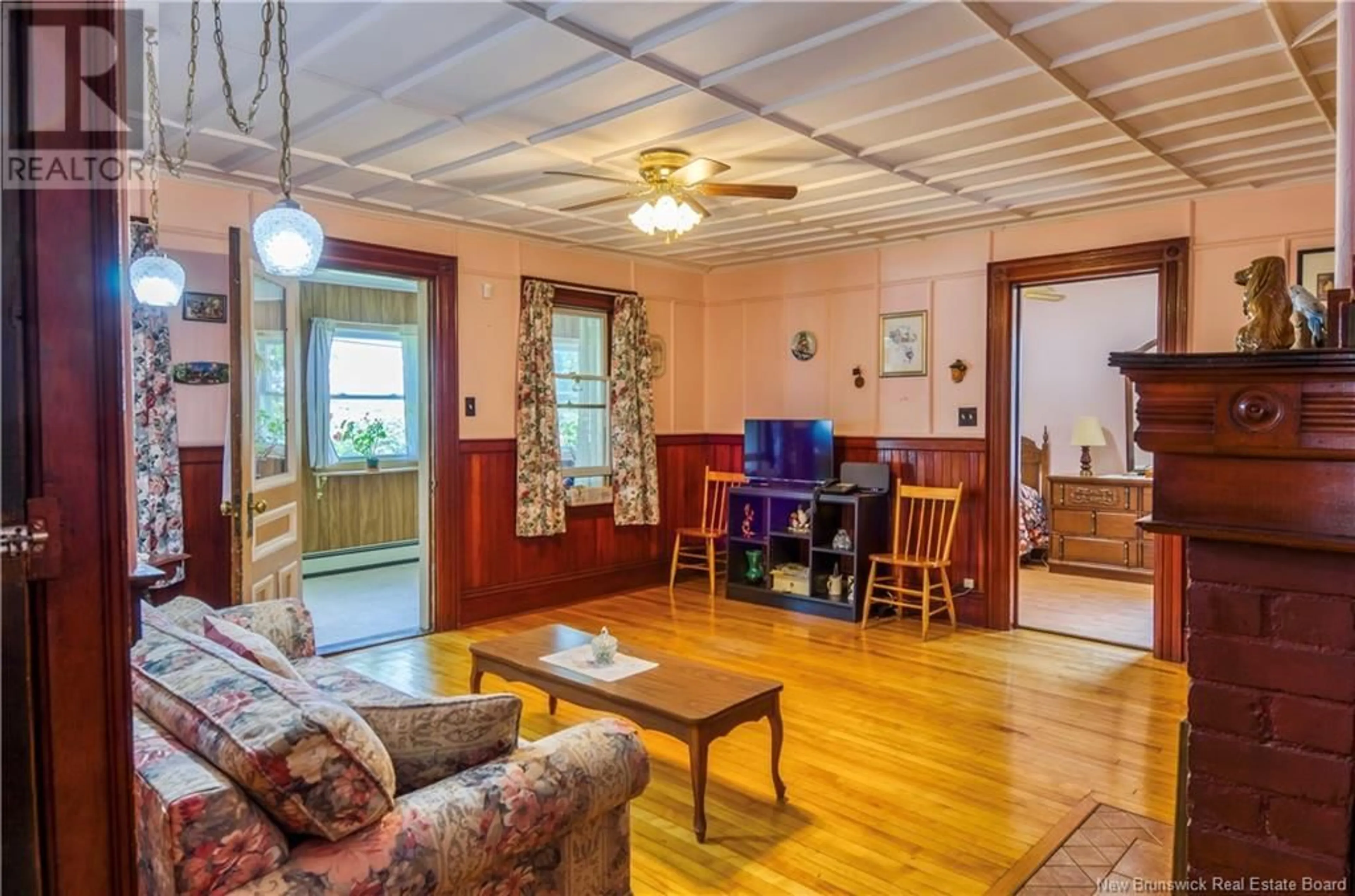 Living room with furniture, wood/laminate floor for 4283 LOCH LOMOND ROAD, Saint John New Brunswick E2N1C7