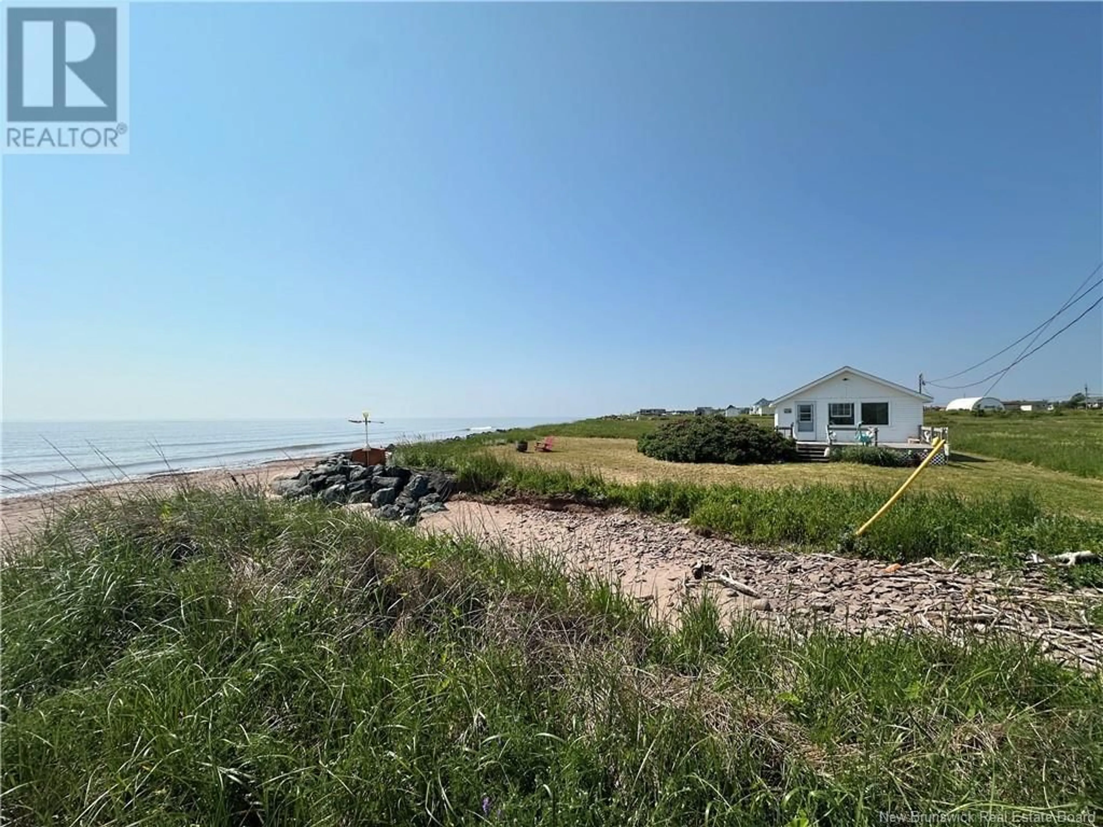 A pic from outside/outdoor area/front of a property/back of a property/a pic from drone, water/lake/river/ocean view for 56 RUE DE LA PLAGE, Cap-Bateau New Brunswick E8T3C7