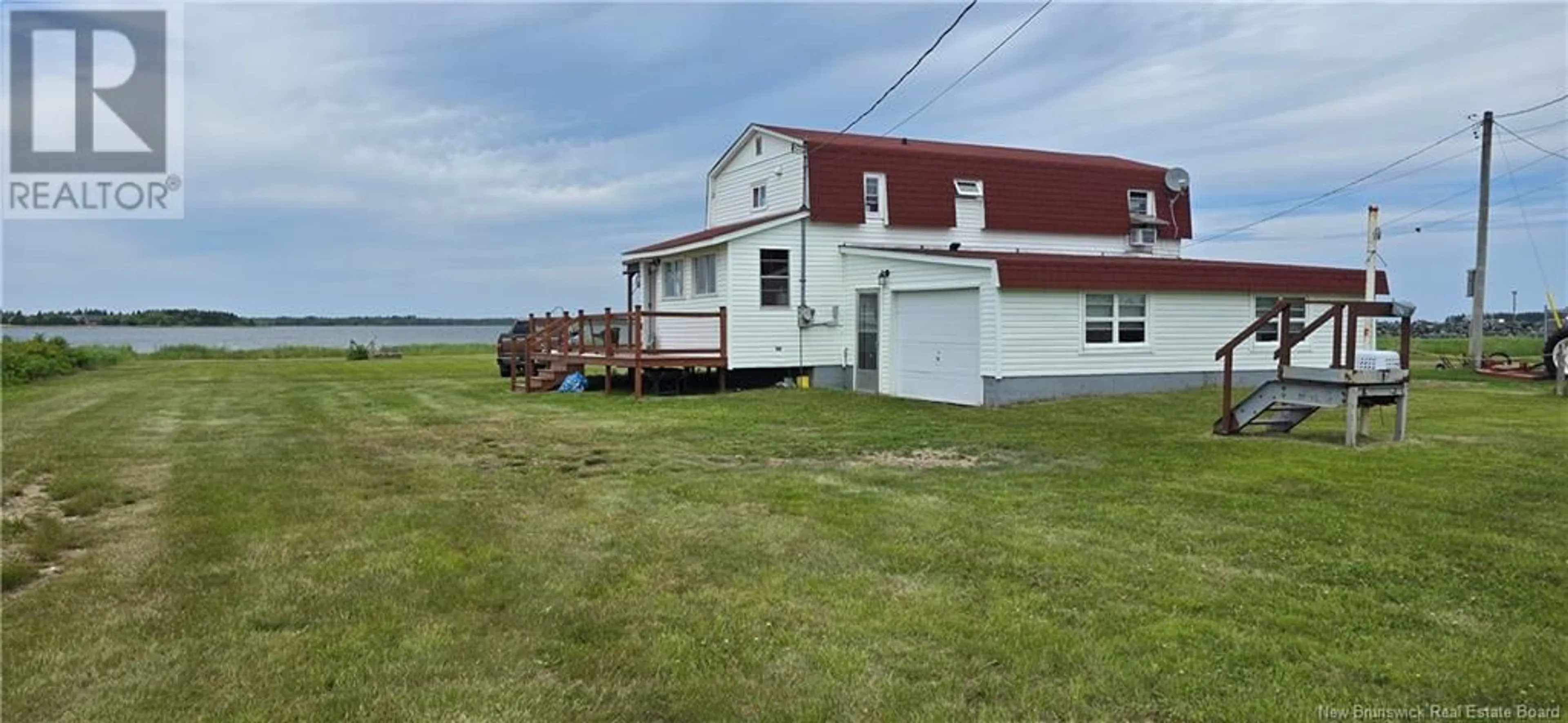 A pic from outside/outdoor area/front of a property/back of a property/a pic from drone, water/lake/river/ocean view for 229 DU PARC, Val-Comeau New Brunswick E1X4B6