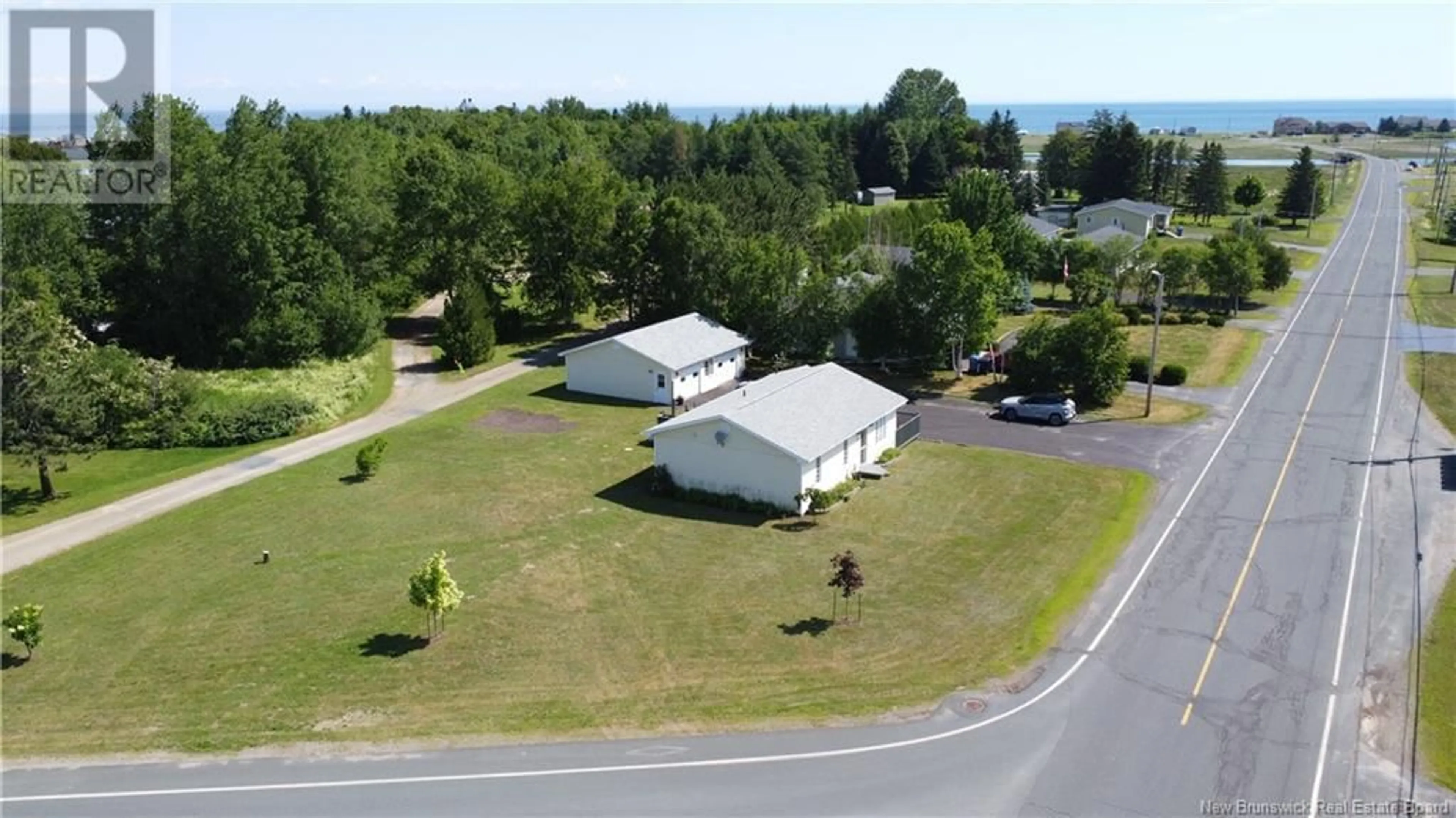 A pic from outside/outdoor area/front of a property/back of a property/a pic from drone, unknown for 102 KENT LODGE, Beresford New Brunswick E8K1B1