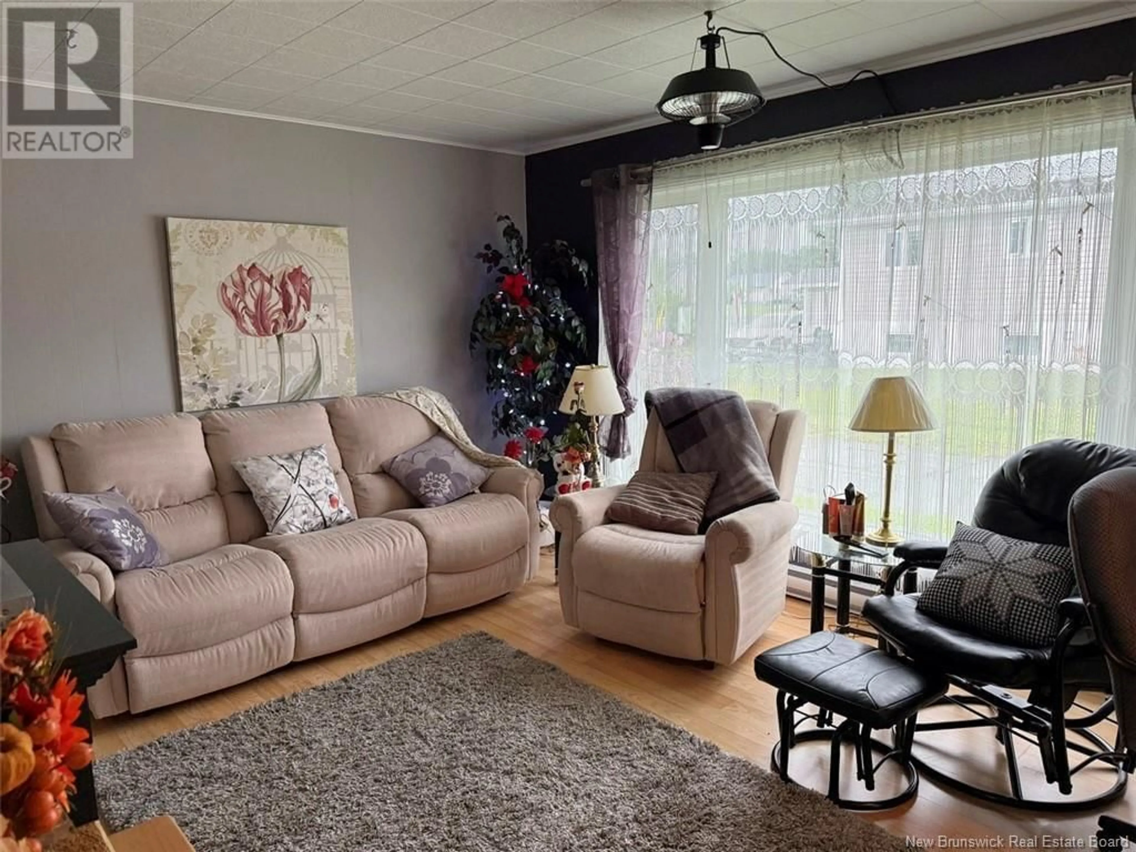 Living room with furniture, wood/laminate floor for 38 MGR MELANSON STREET, Saint-Quentin New Brunswick E8A1X3