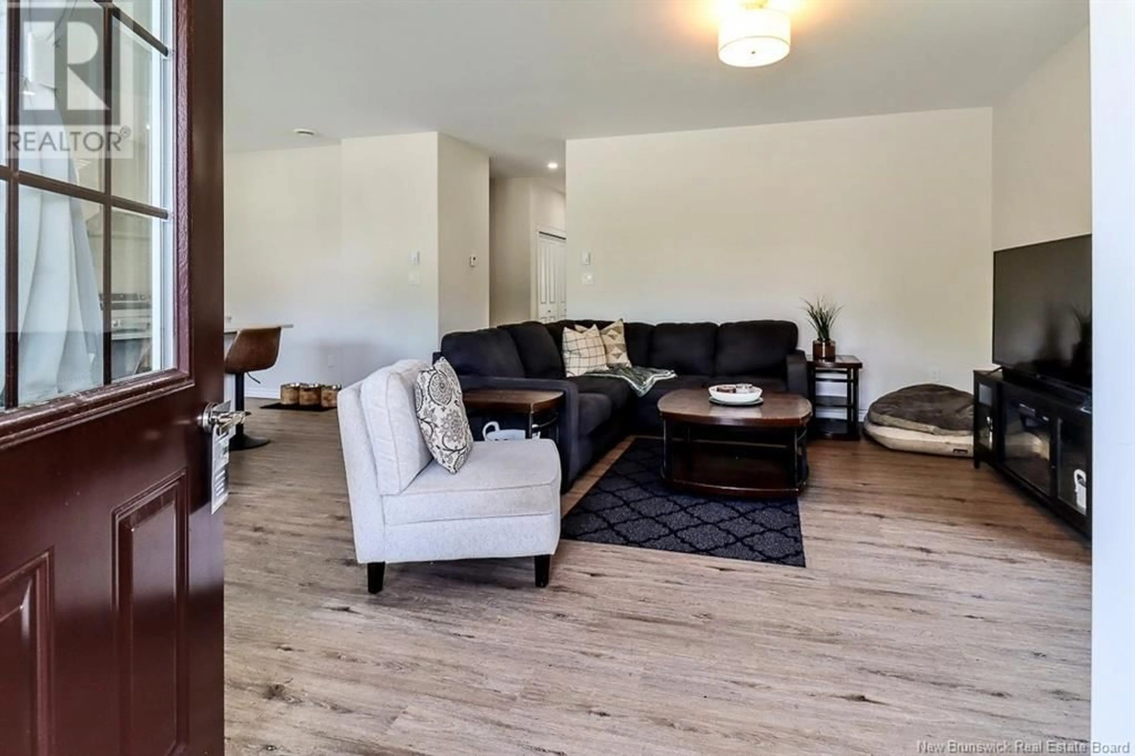 Living room with furniture, wood/laminate floor for 974 KENNEBECASIS DRIVE, Saint John New Brunswick E2K5A8