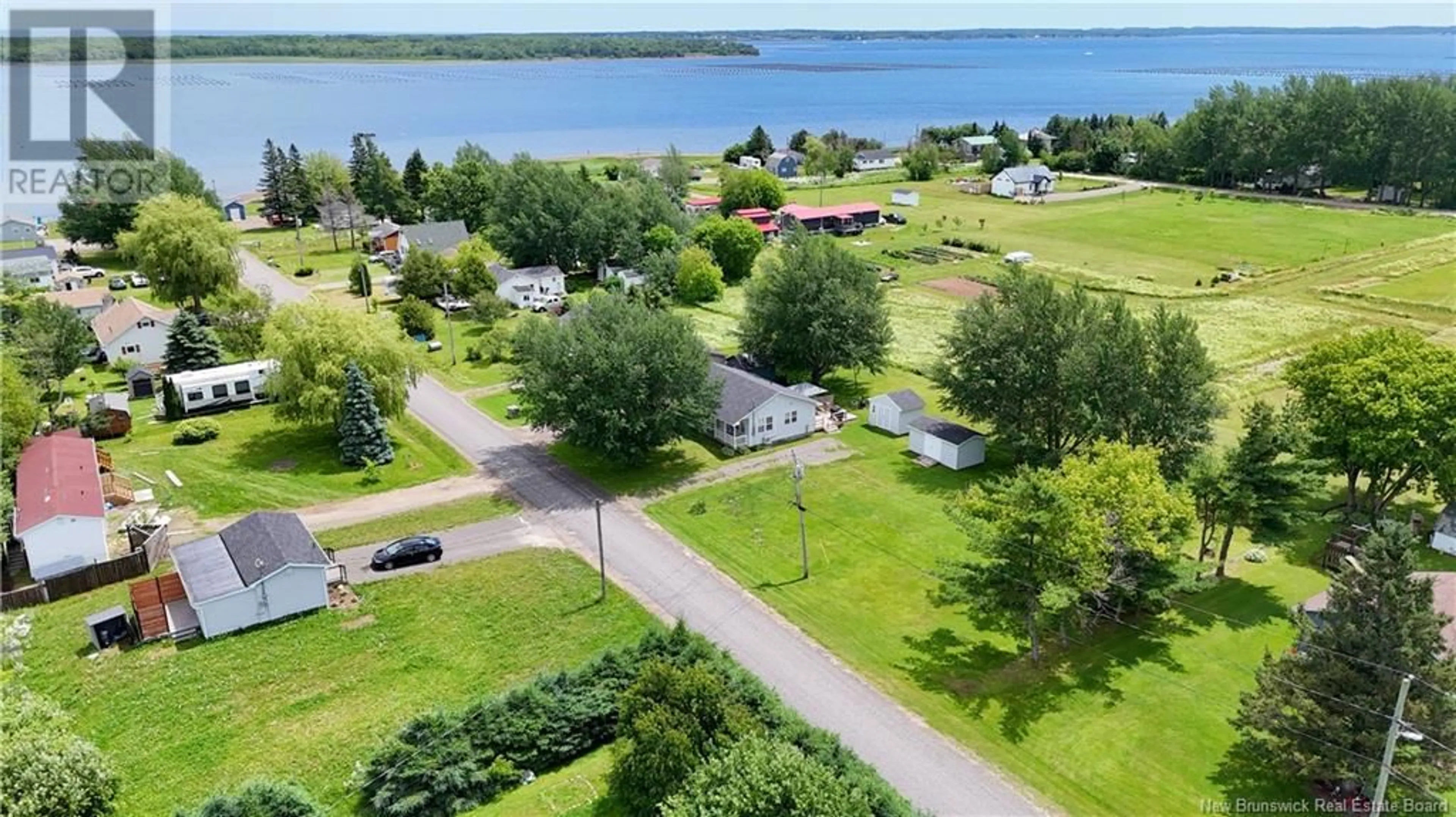 A pic from outside/outdoor area/front of a property/back of a property/a pic from drone, water/lake/river/ocean view for 42 BRAY BOULEVARD, Cocagne New Brunswick E4R2G4