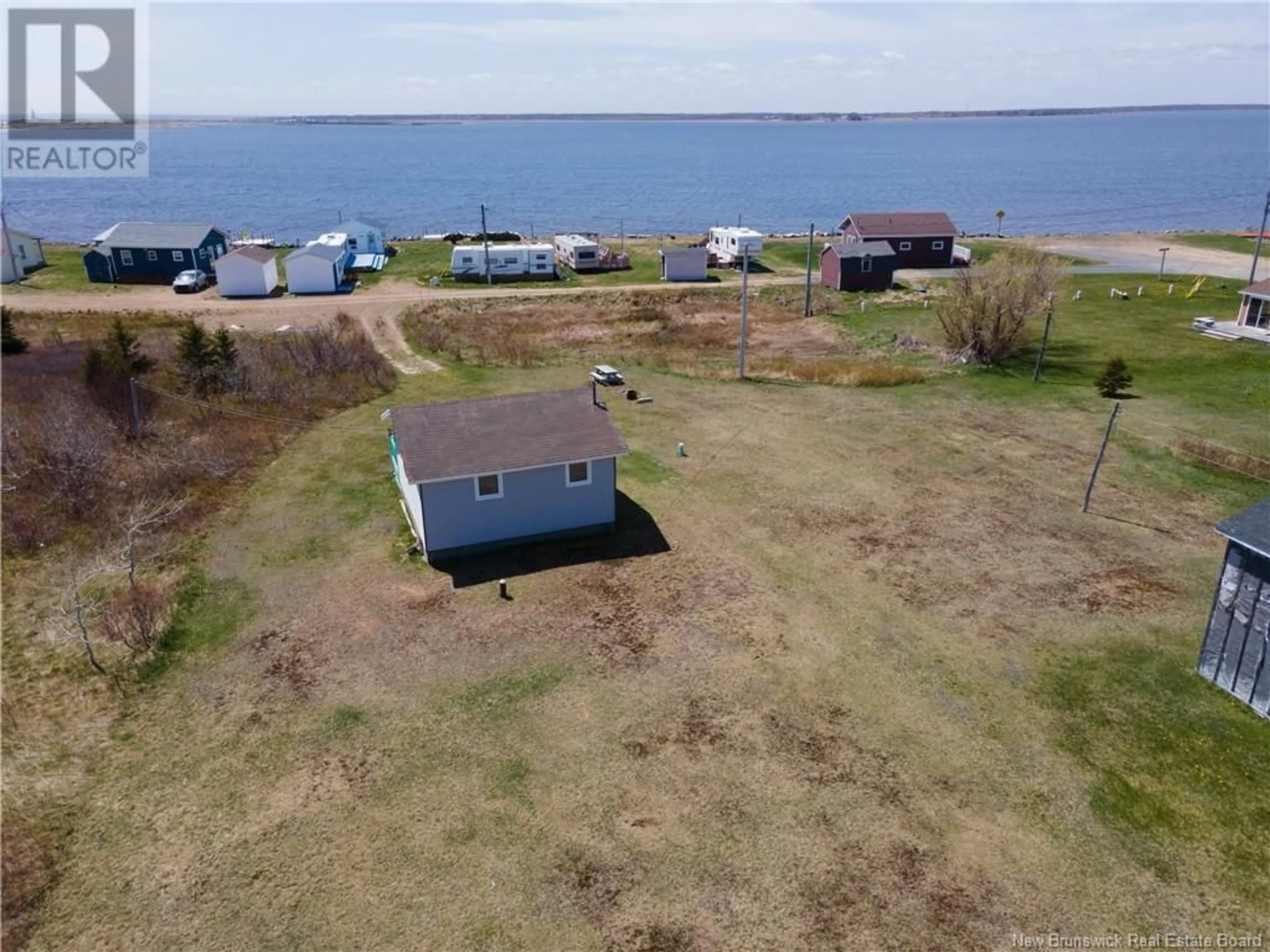 A pic from outside/outdoor area/front of a property/back of a property/a pic from drone, water/lake/river/ocean view for 15 DES HIRONDELLES, Chiasson Office New Brunswick E8S2N4
