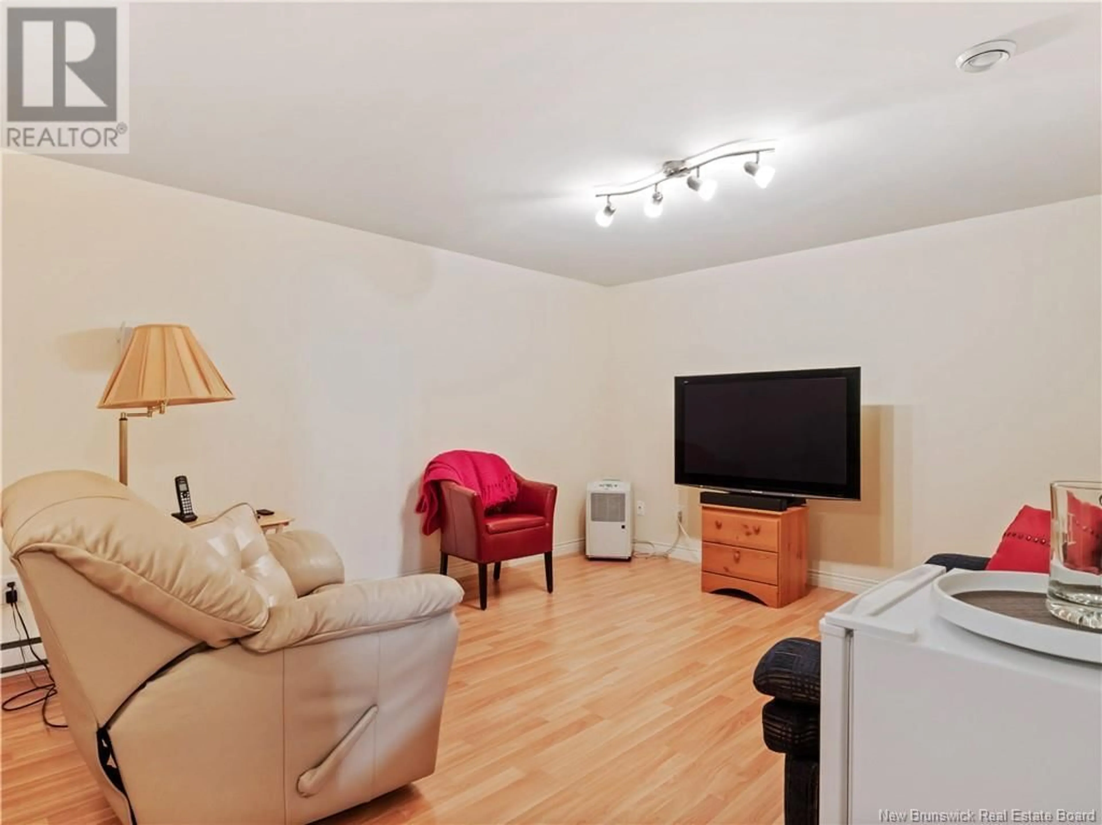Living room with furniture, wood/laminate floor for 5 - 114 DOMETHILDE, Dieppe New Brunswick E1A8R3