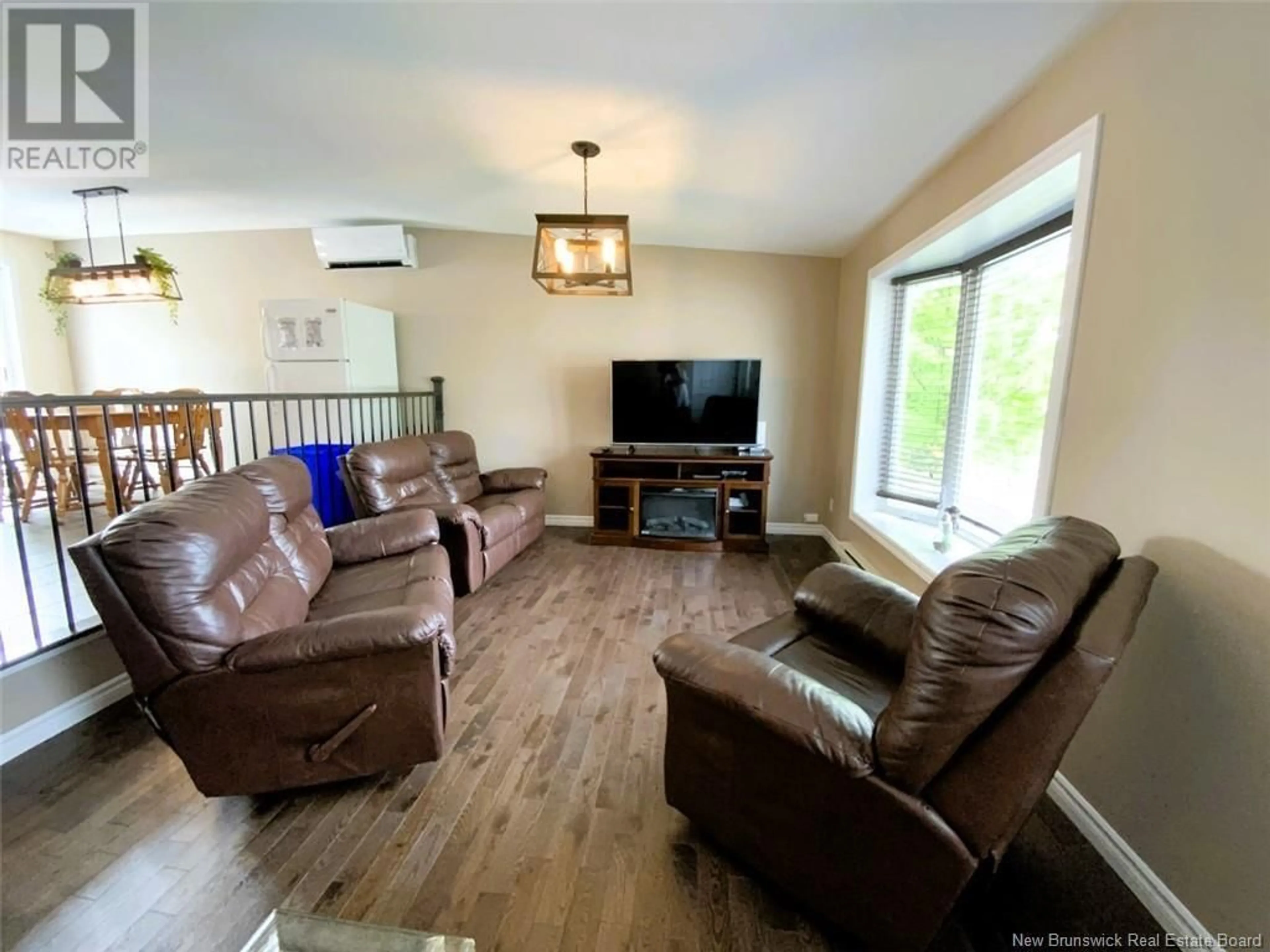 Living room with furniture, wood/laminate floor for 133 CHEMIN DU POUVOIR ROAD, Edmundston New Brunswick E3V2Y2