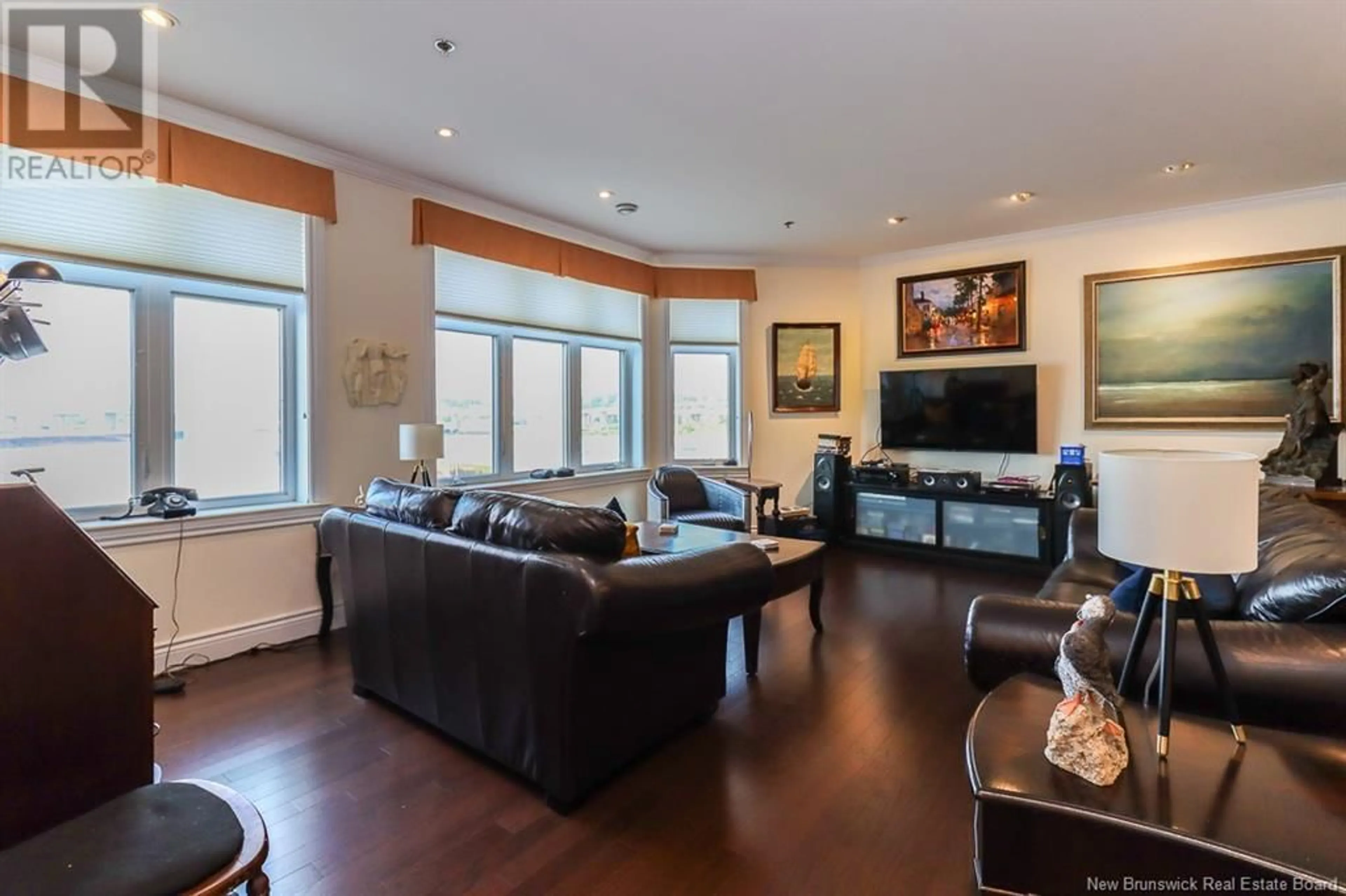 Living room with furniture, wood/laminate floor for 303 - 65 SMYTHE, Saint John New Brunswick E2L0A1