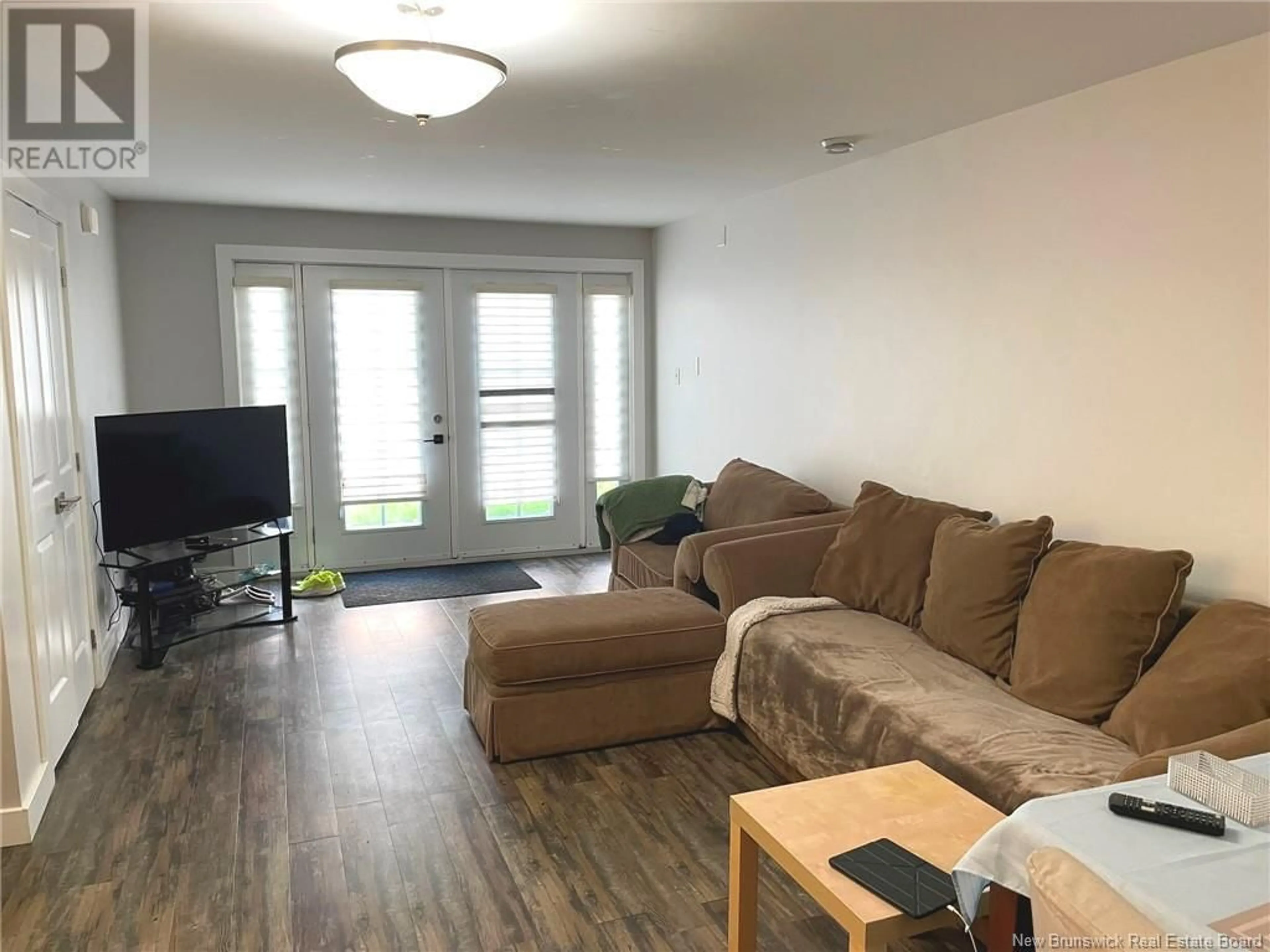 Living room with furniture, wood/laminate floor for 113 - 9 CATHEDRAL LANE, Saint John New Brunswick E2L0E7