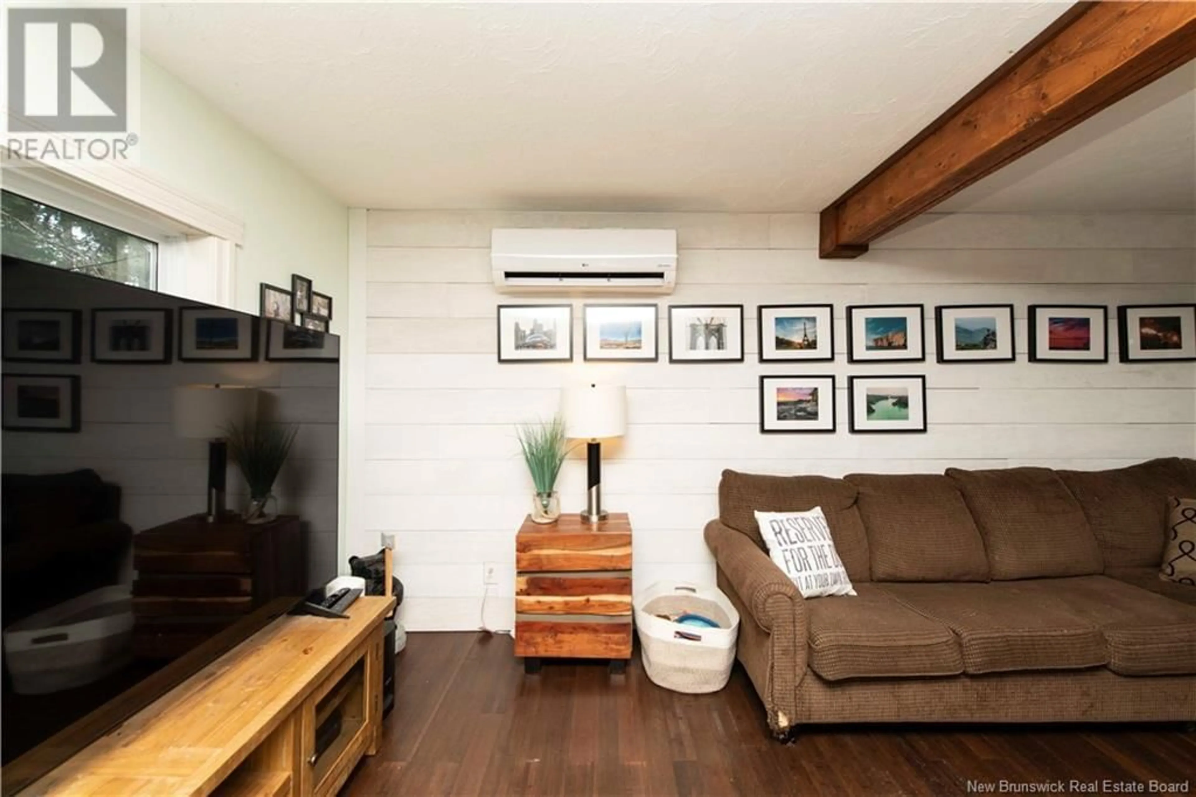 Living room with furniture, wood/laminate floor for 49 STOREY ROAD, Moncton New Brunswick E1A2W6