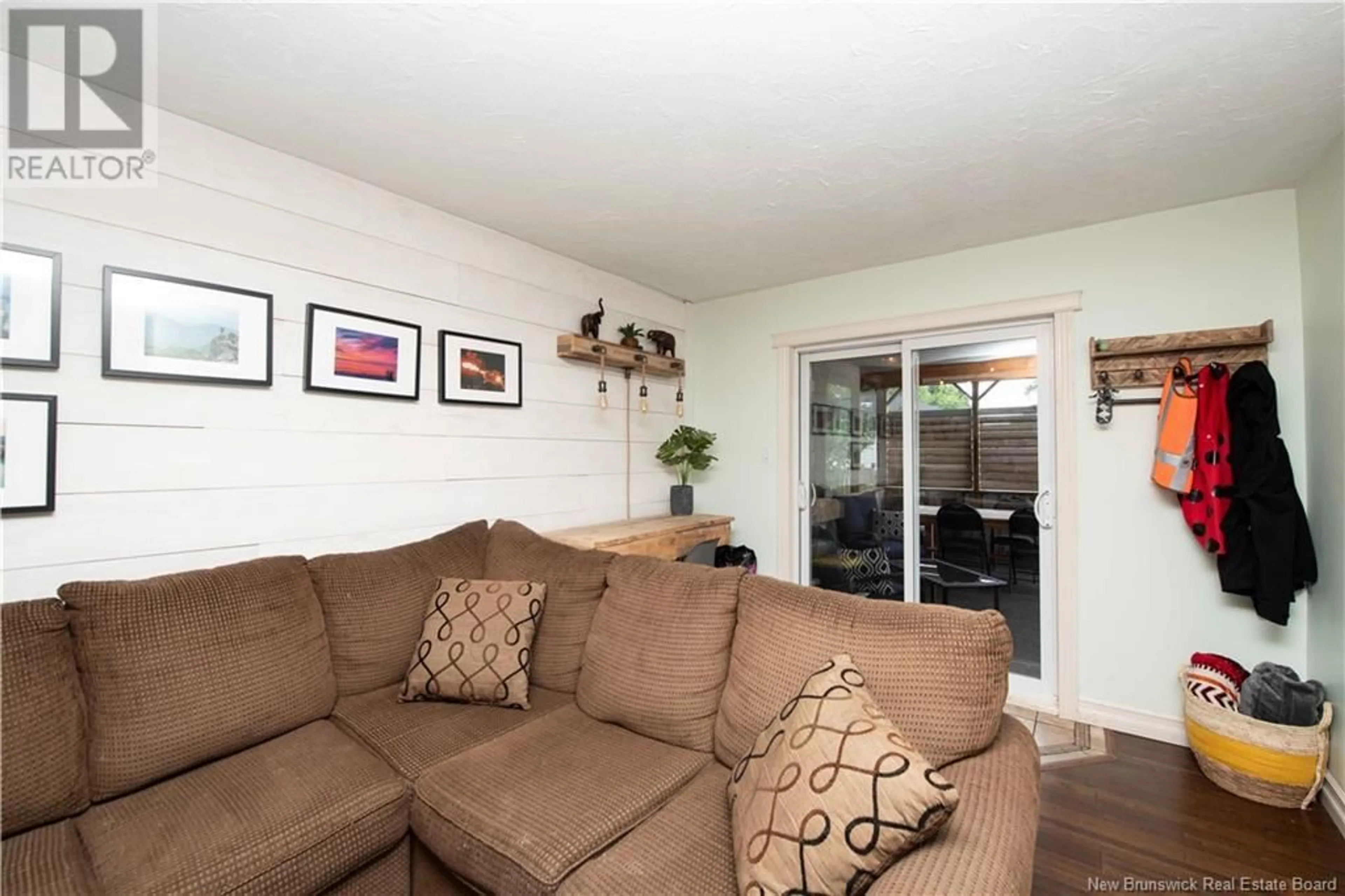 Living room with furniture, wood/laminate floor for 49 STOREY ROAD, Moncton New Brunswick E1A2W6