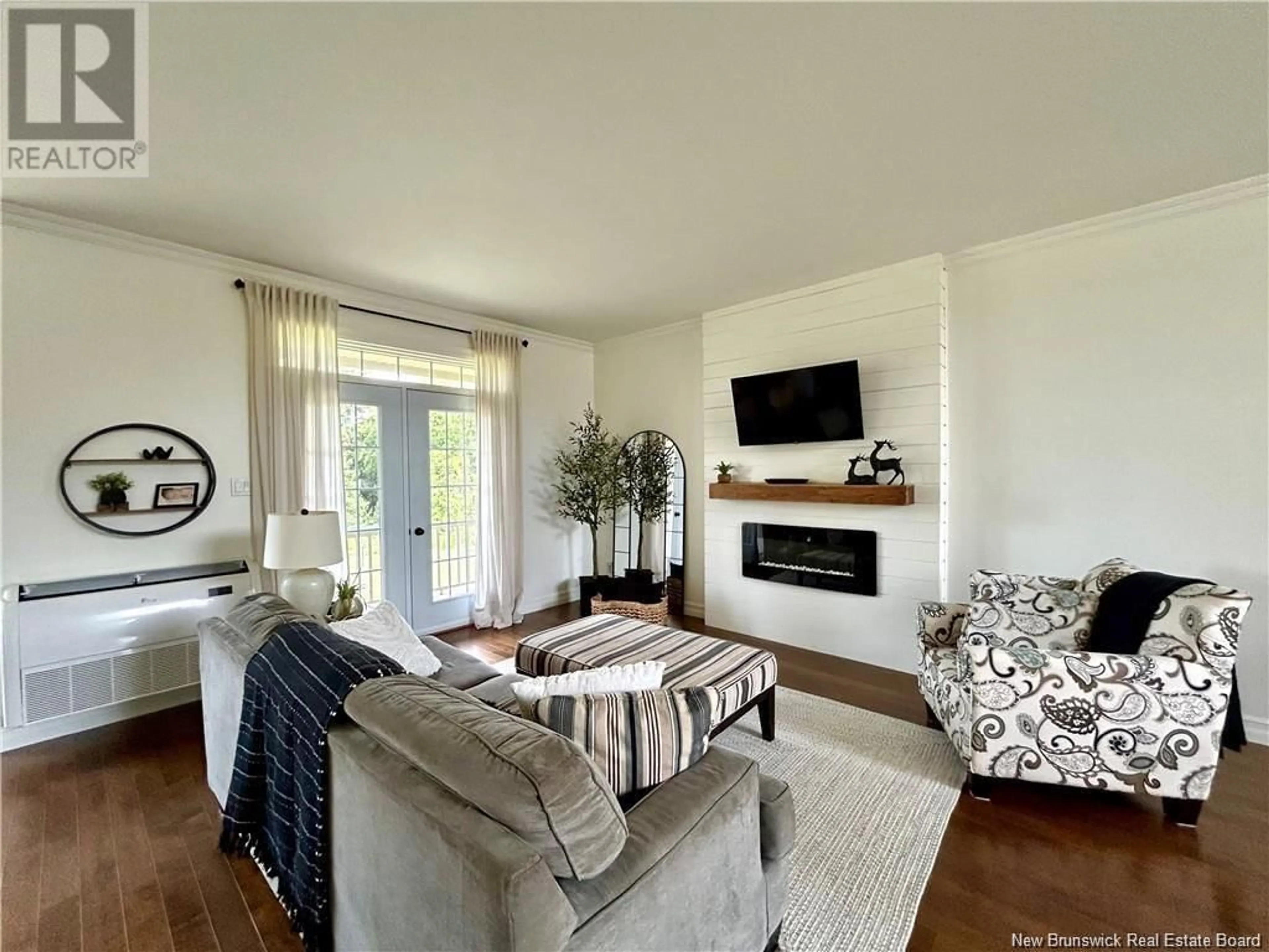 Living room with furniture, wood/laminate floor for 47 BROOK TERRACE, Campbellton New Brunswick E3N3T3