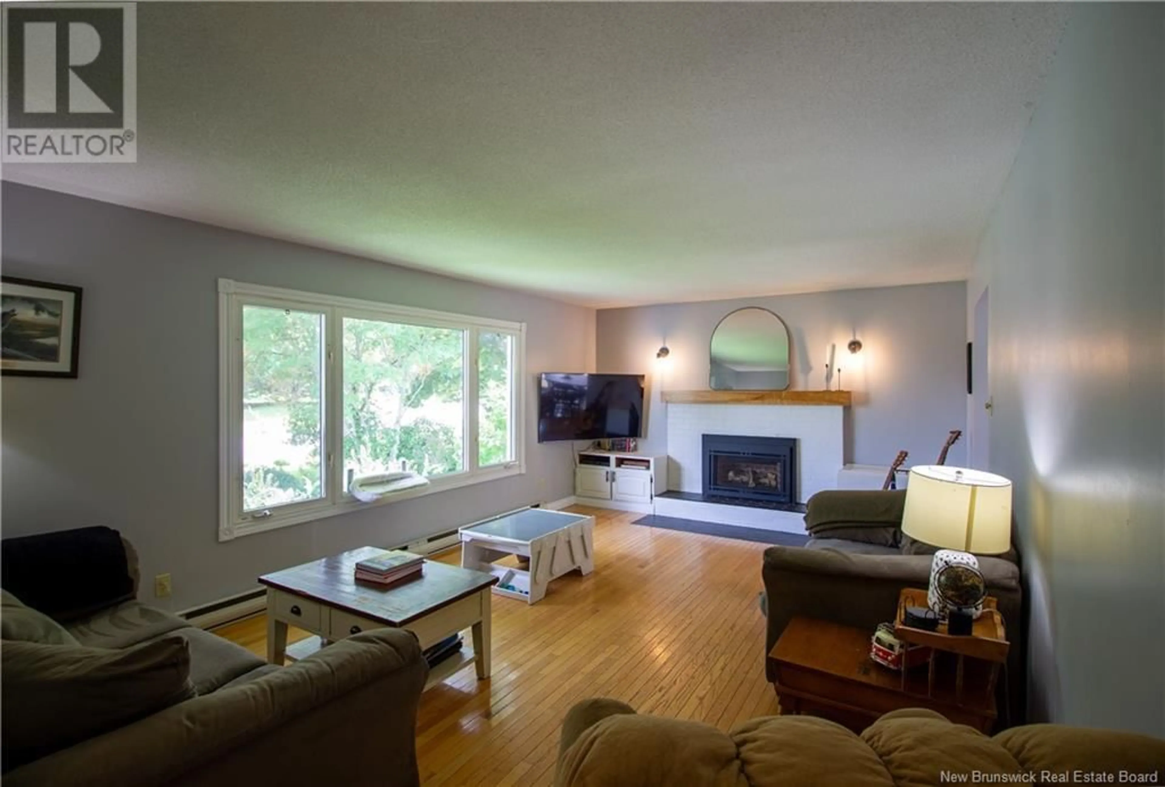 Living room with furniture, wood/laminate floor for 16 SAUNDERS STREET, Nauwigewauk New Brunswick E5N6V3