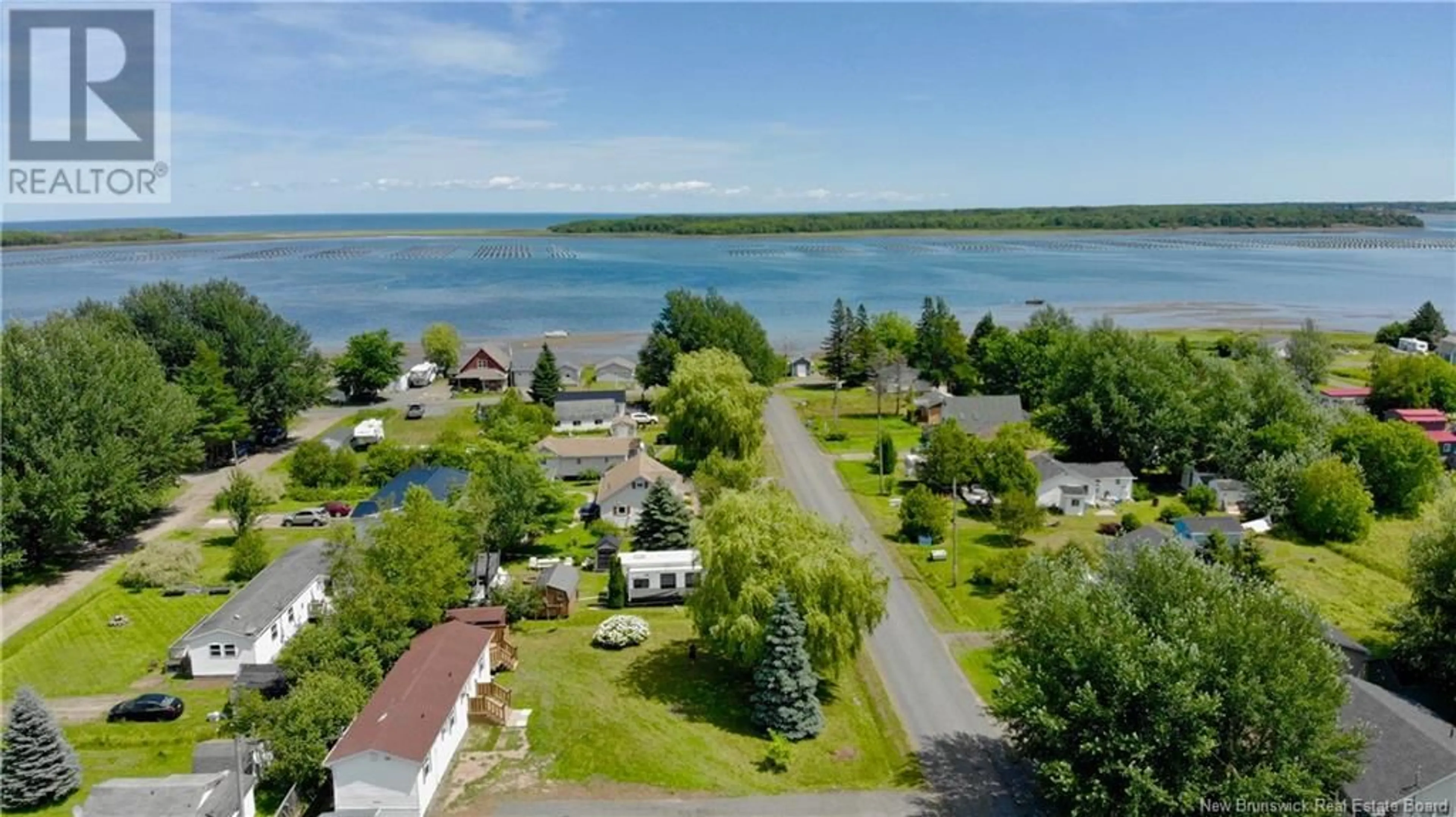 A pic from outside/outdoor area/front of a property/back of a property/a pic from drone, water/lake/river/ocean view for 43 BRAY BOULEVARD, Cocagne New Brunswick E4R3T1