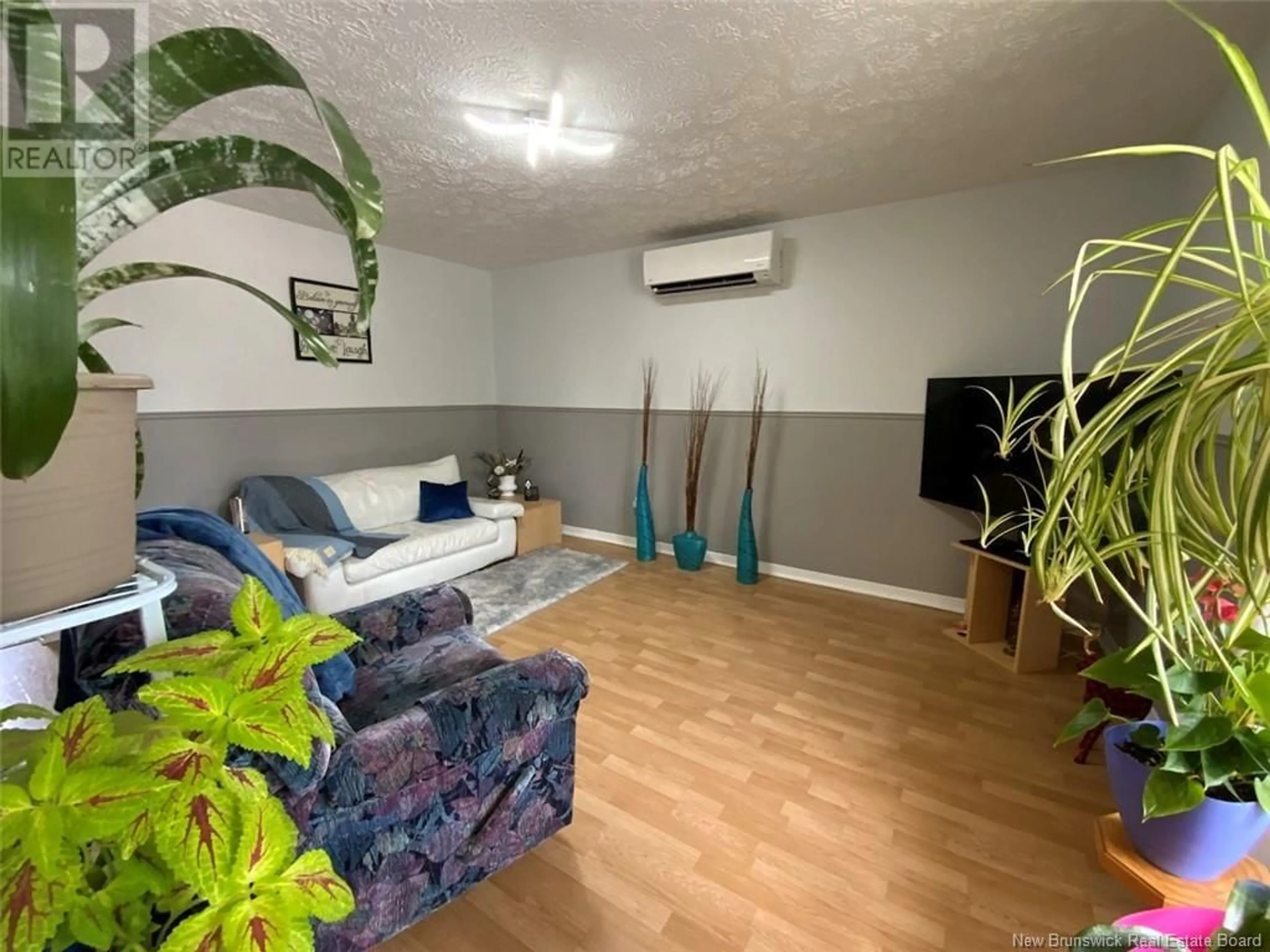 Living room with furniture, wood/laminate floor for 565 RUE PRINCIPALE STREET, Clair New Brunswick E7A2G8