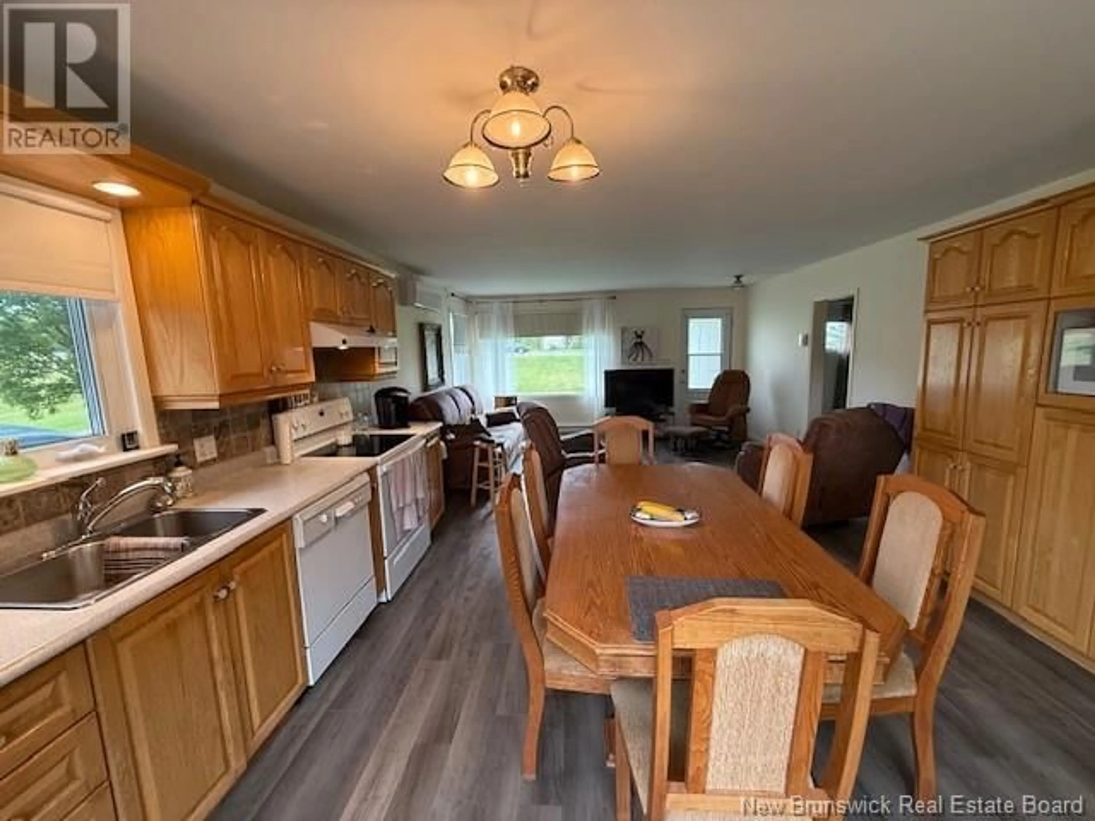 Open concept kitchen, wood/laminate floor for 1184 DES PIONNIERS AVENUE, Balmoral New Brunswick E8E2X3