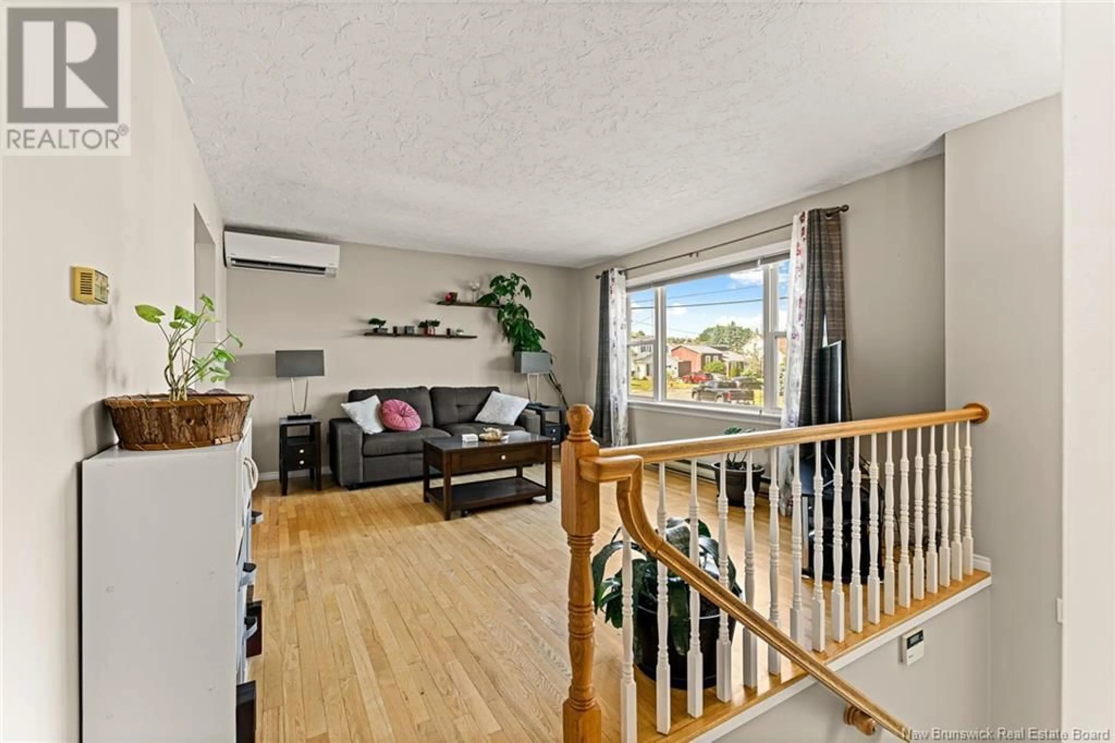 Living room with furniture, wood/laminate floor for 54 CASTLE, Moncton New Brunswick E1A6M1