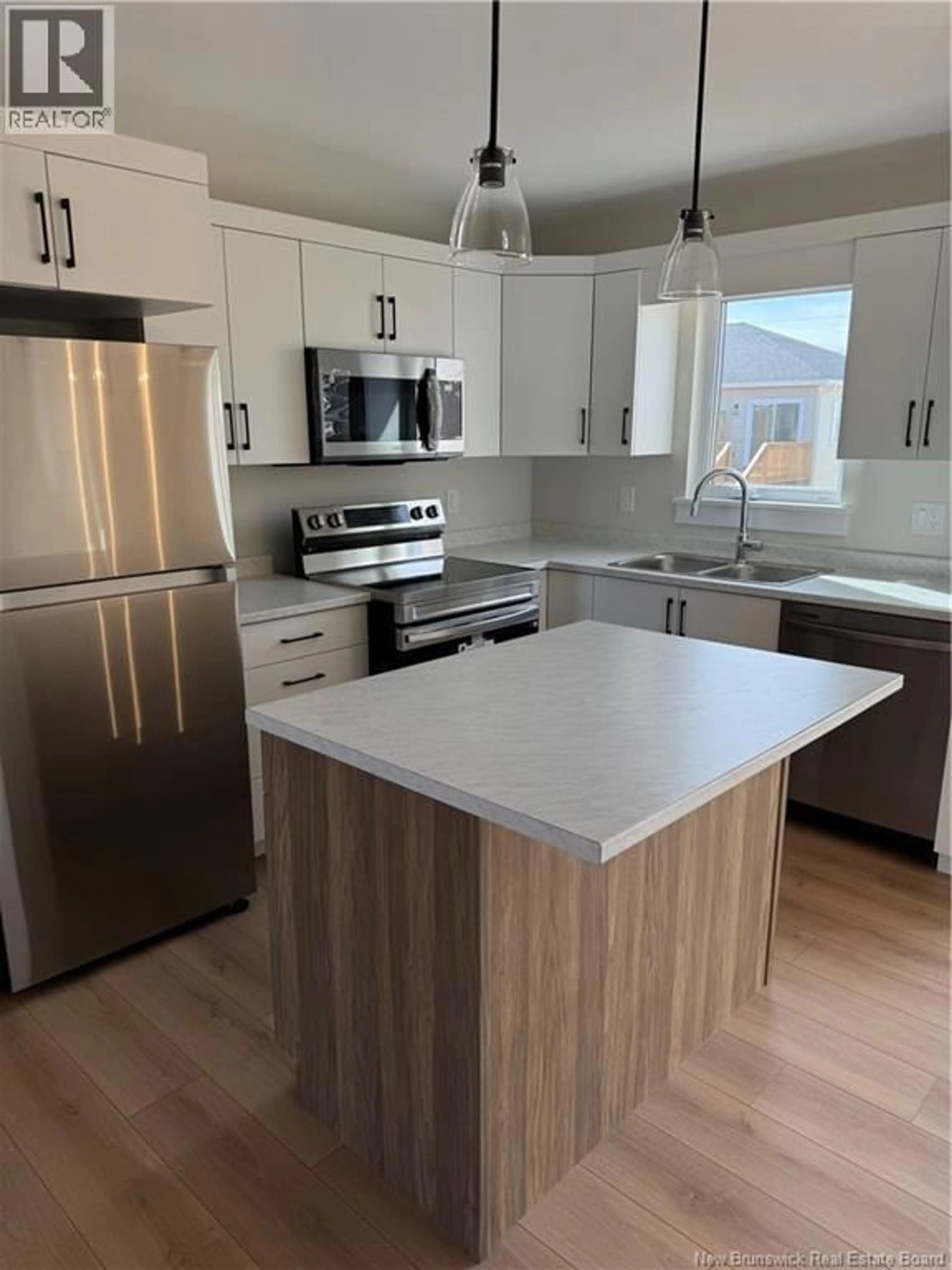 Open concept kitchen, wood/laminate floor for 56 ALOSIER CRESCENT, Moncton New Brunswick E1K0A1