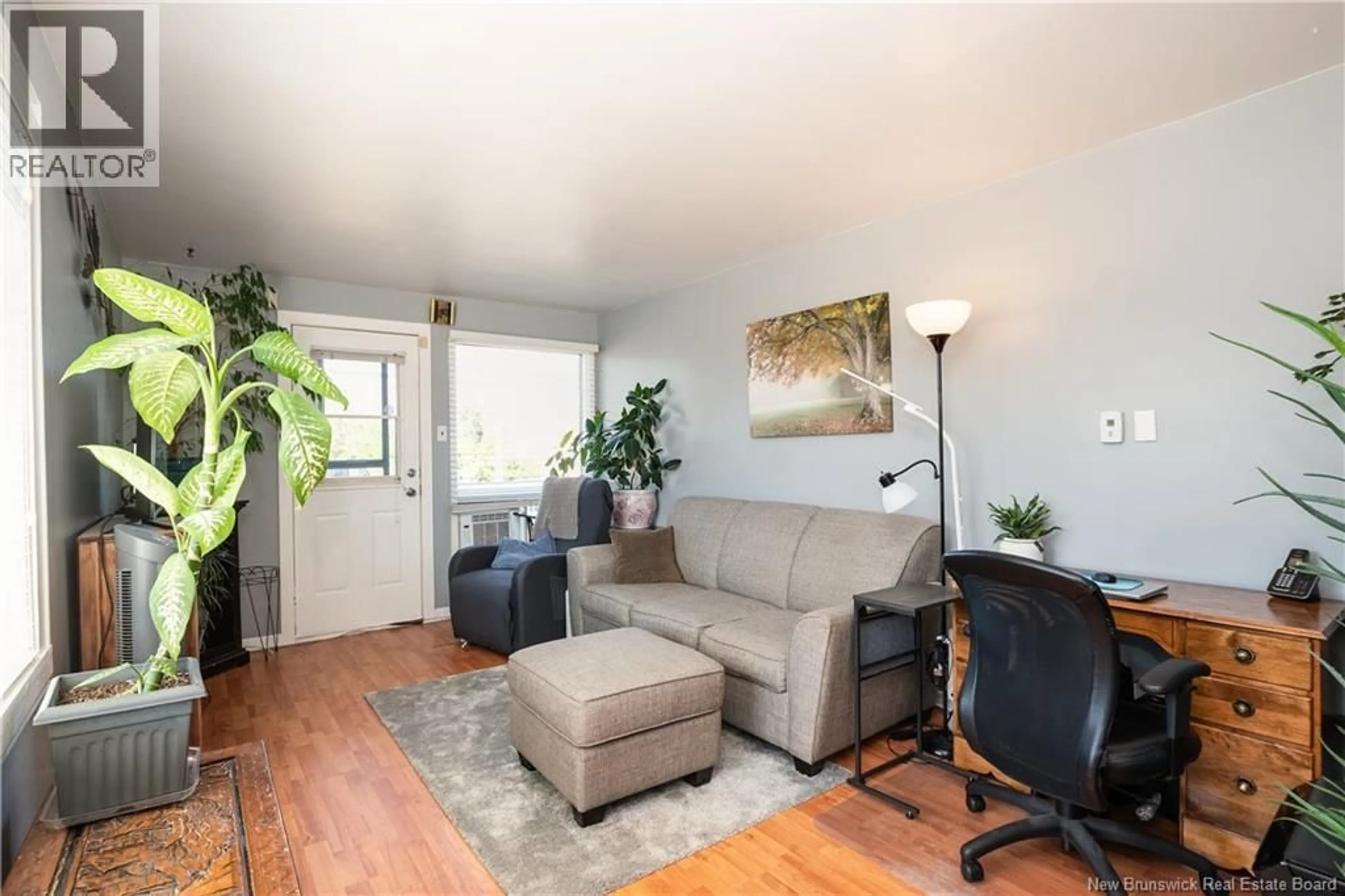Living room with furniture, wood/laminate floor for 27 CHURCHILL STREET, Moncton New Brunswick E1C7H8