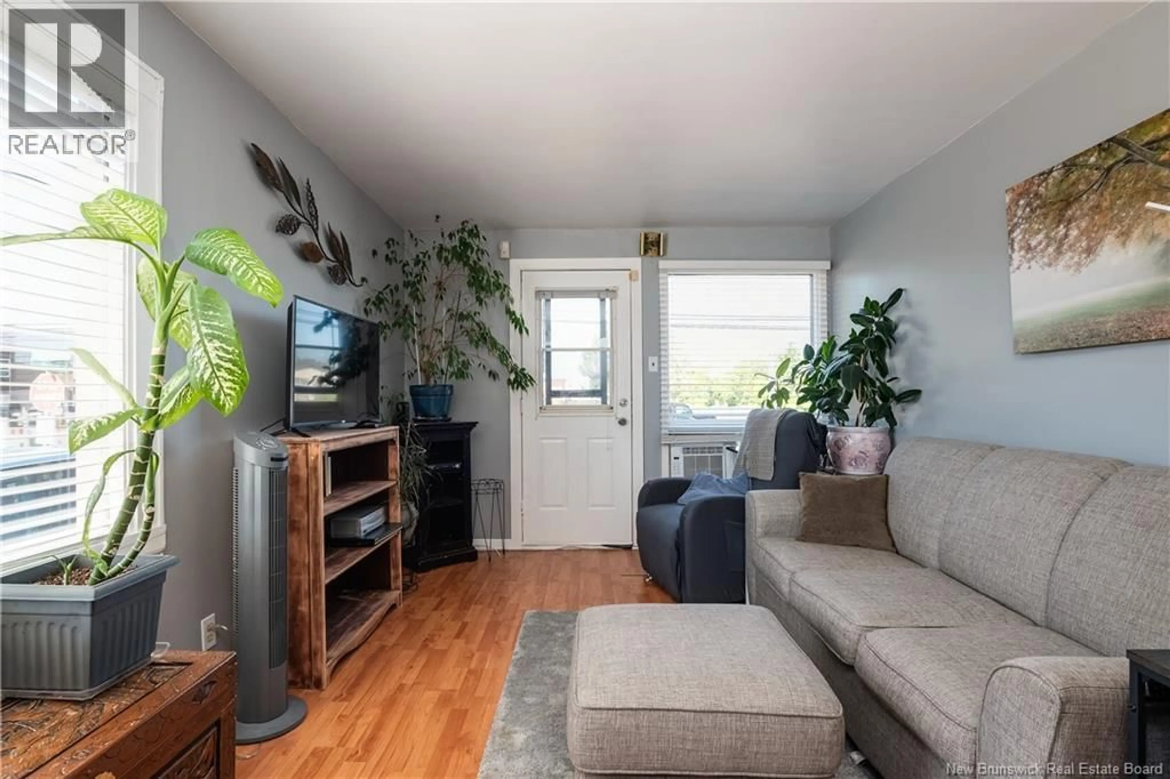 Living room with furniture, wood/laminate floor for 27 CHURCHILL STREET, Moncton New Brunswick E1C7H8