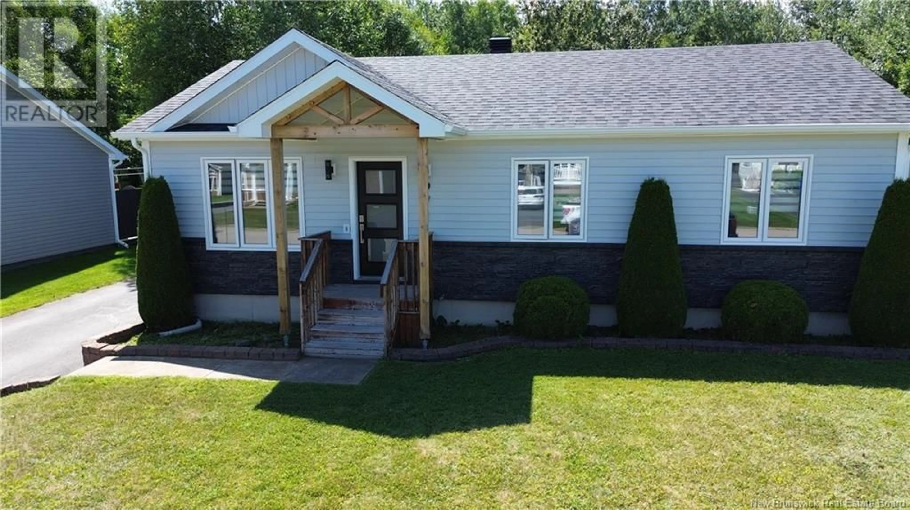 Home with vinyl exterior material, street for 971 RUE DES HUARDS, Beresford New Brunswick E8K1K5