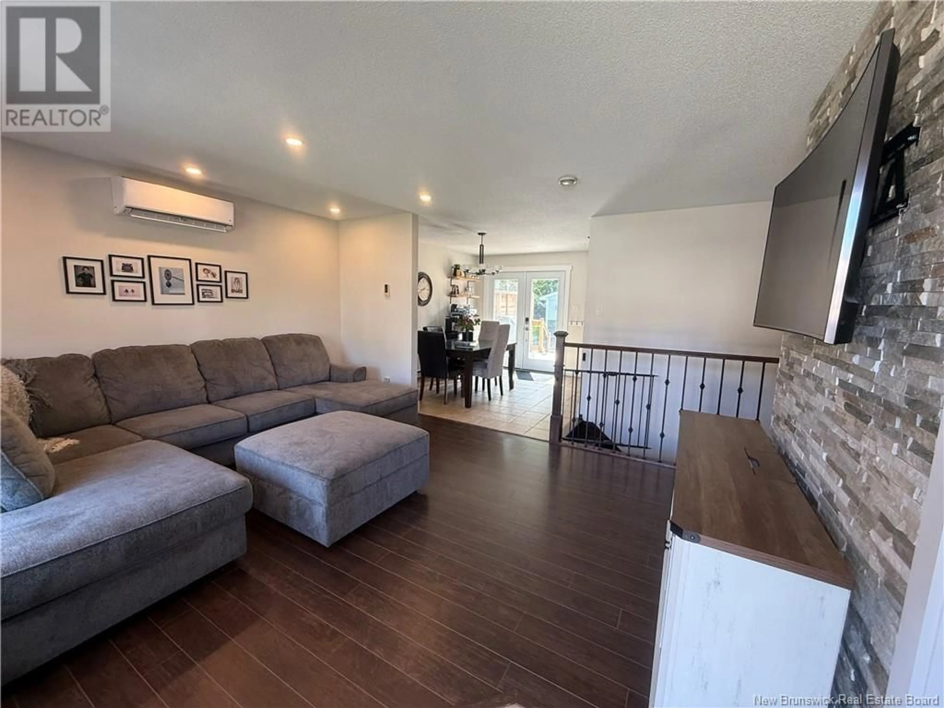 Living room with furniture, wood/laminate floor for 971 RUE DES HUARDS, Beresford New Brunswick E8K1K5