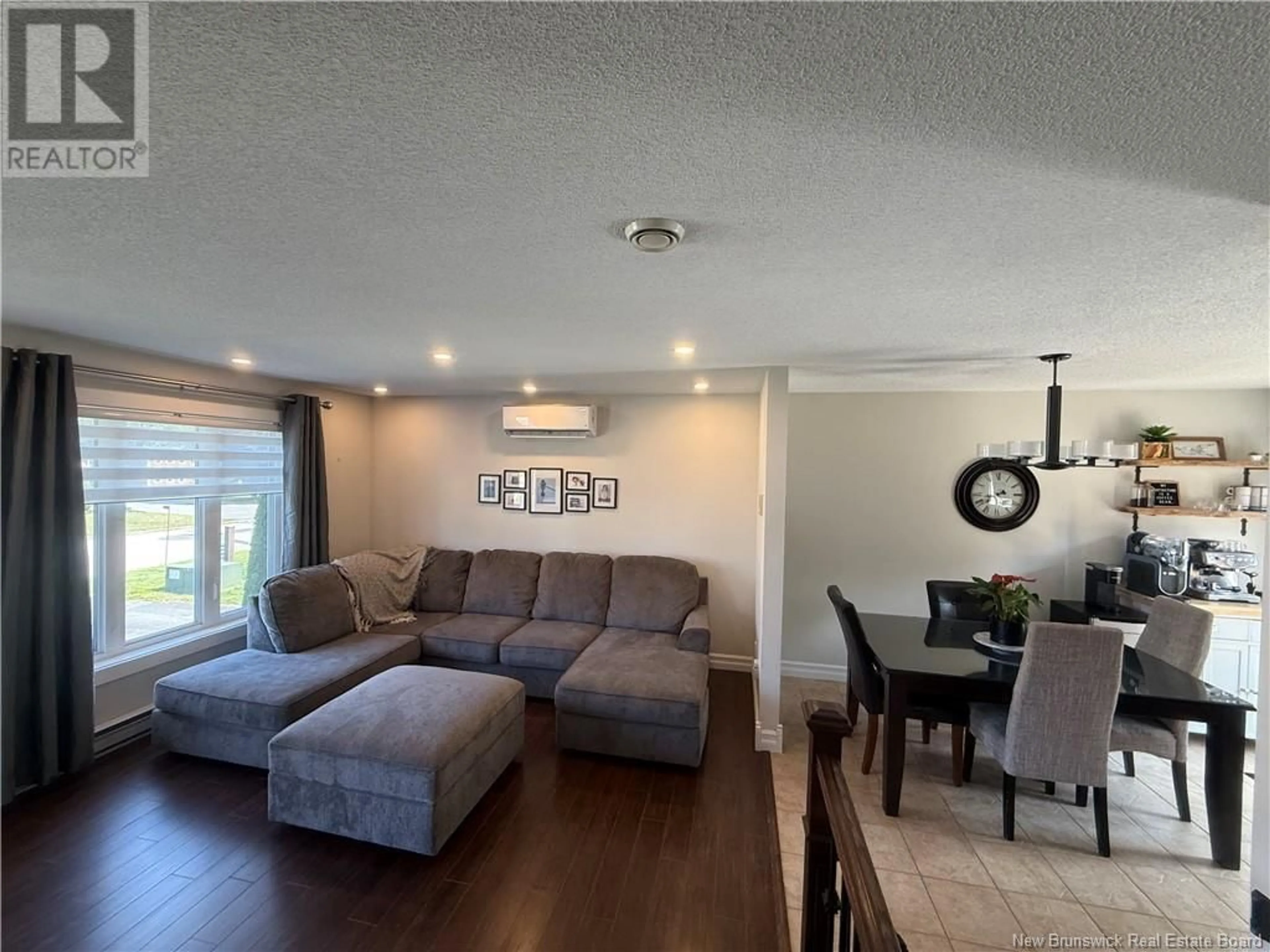 Living room with furniture, wood/laminate floor for 971 RUE DES HUARDS, Beresford New Brunswick E8K1K5