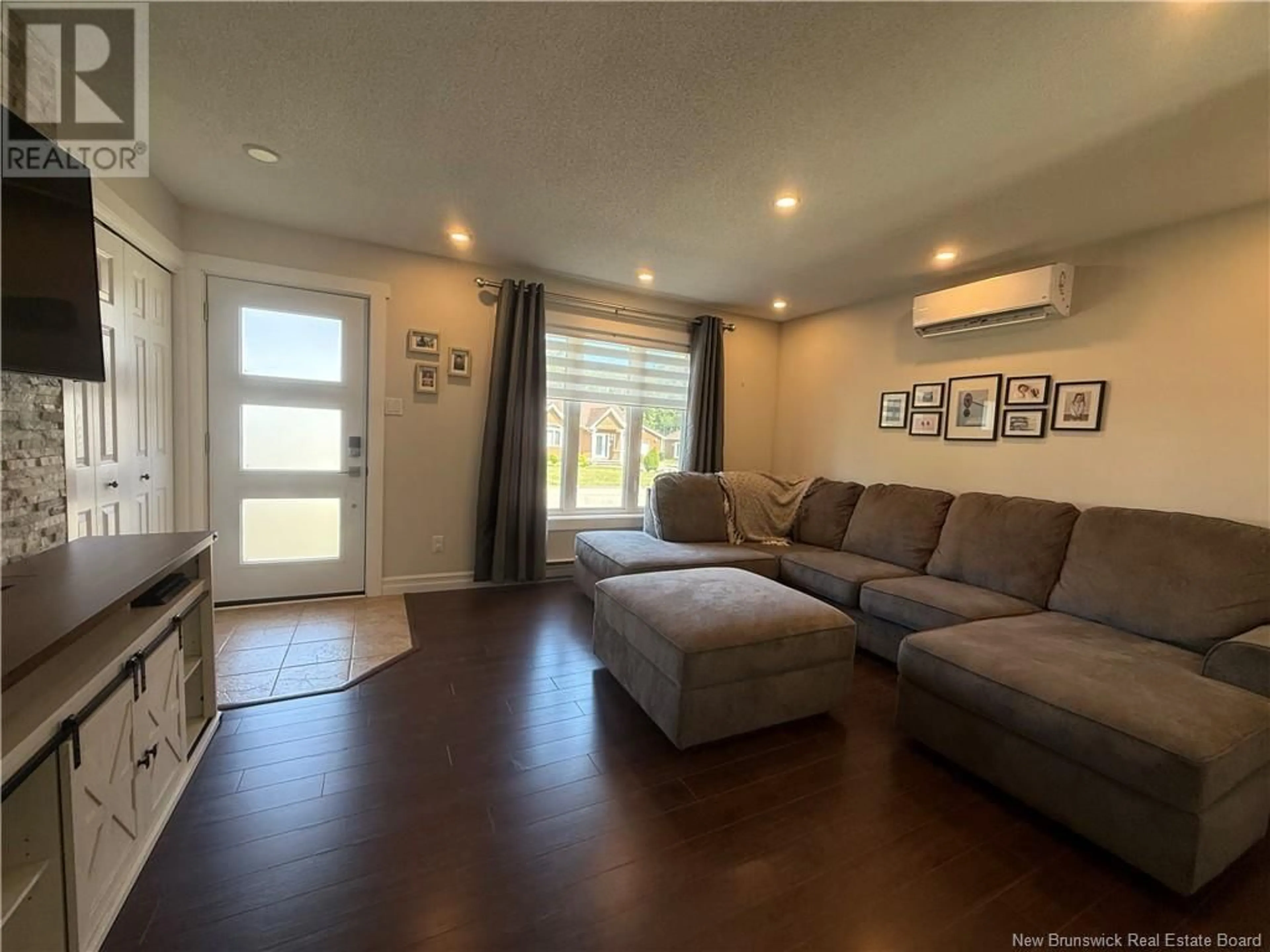 Living room with furniture, wood/laminate floor for 971 RUE DES HUARDS, Beresford New Brunswick E8K1K5