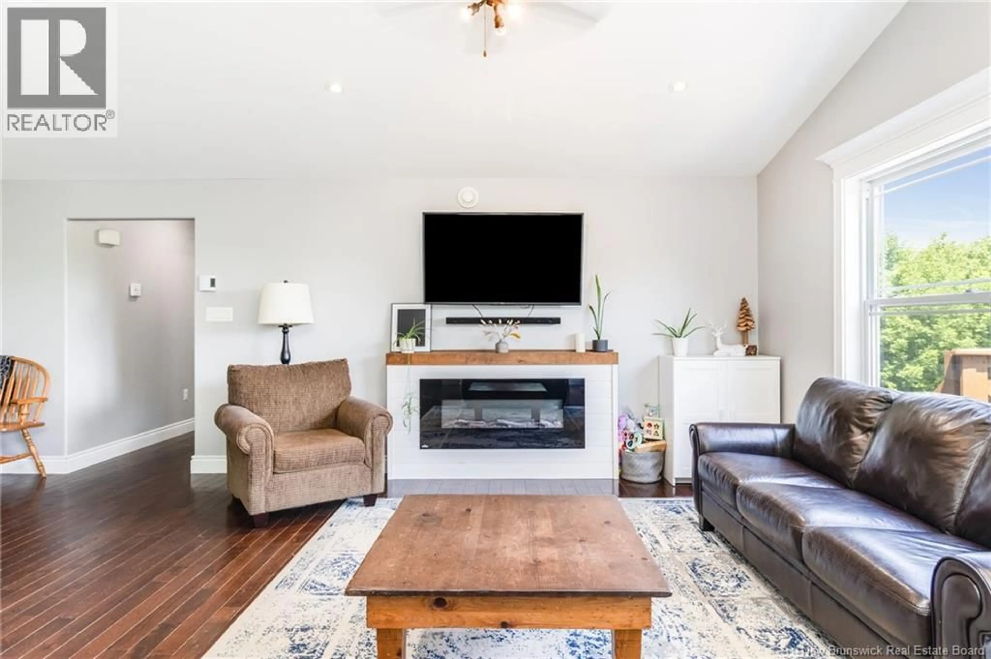 Living room with furniture, wood/laminate floor for 6105 ROUTE 102, Prince William New Brunswick E6K3S5