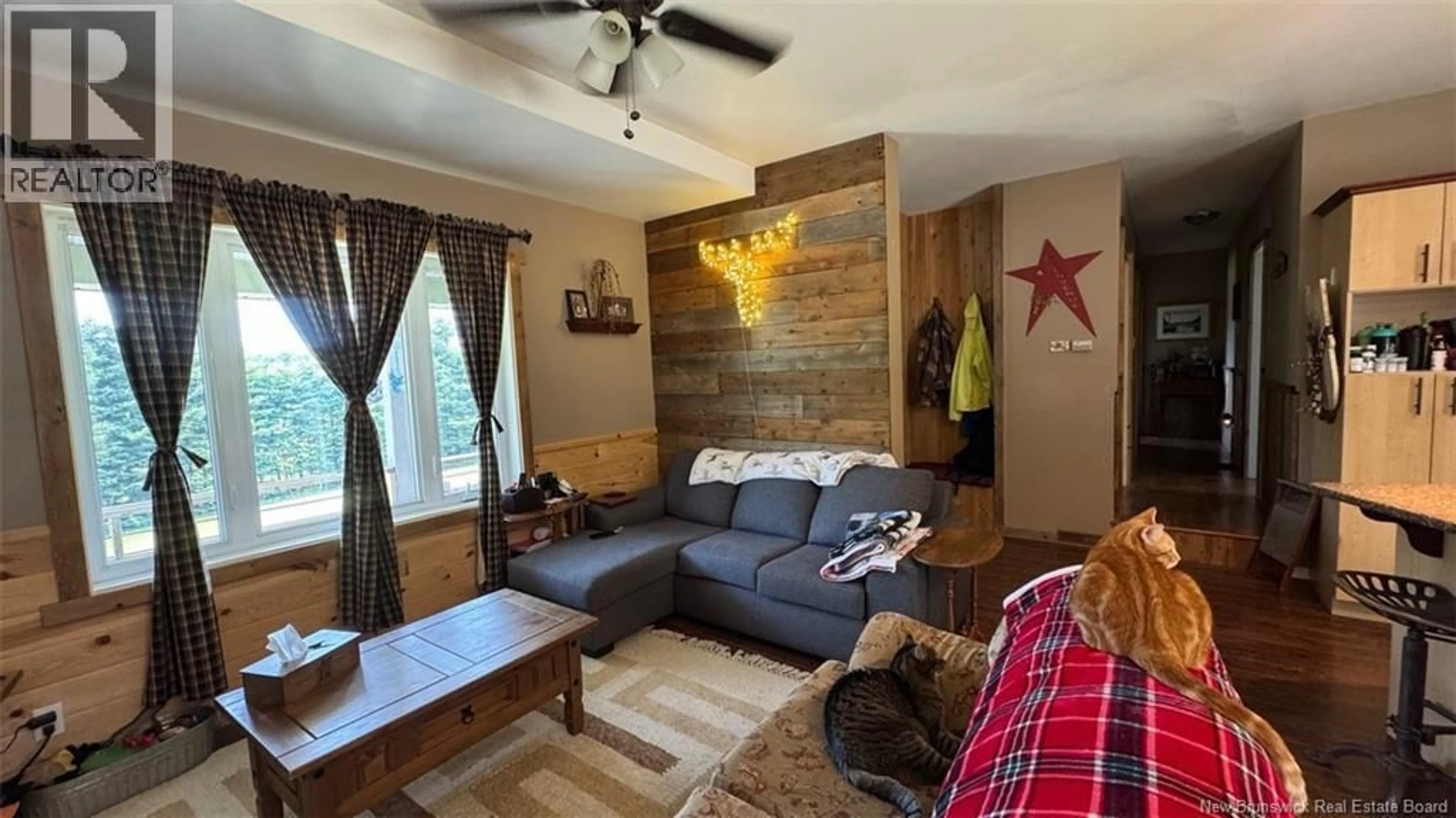Living room with furniture, wood/laminate floor for 402 ROUSSEL MARTIN ROAD, Saint-Joseph New Brunswick E7B2R5