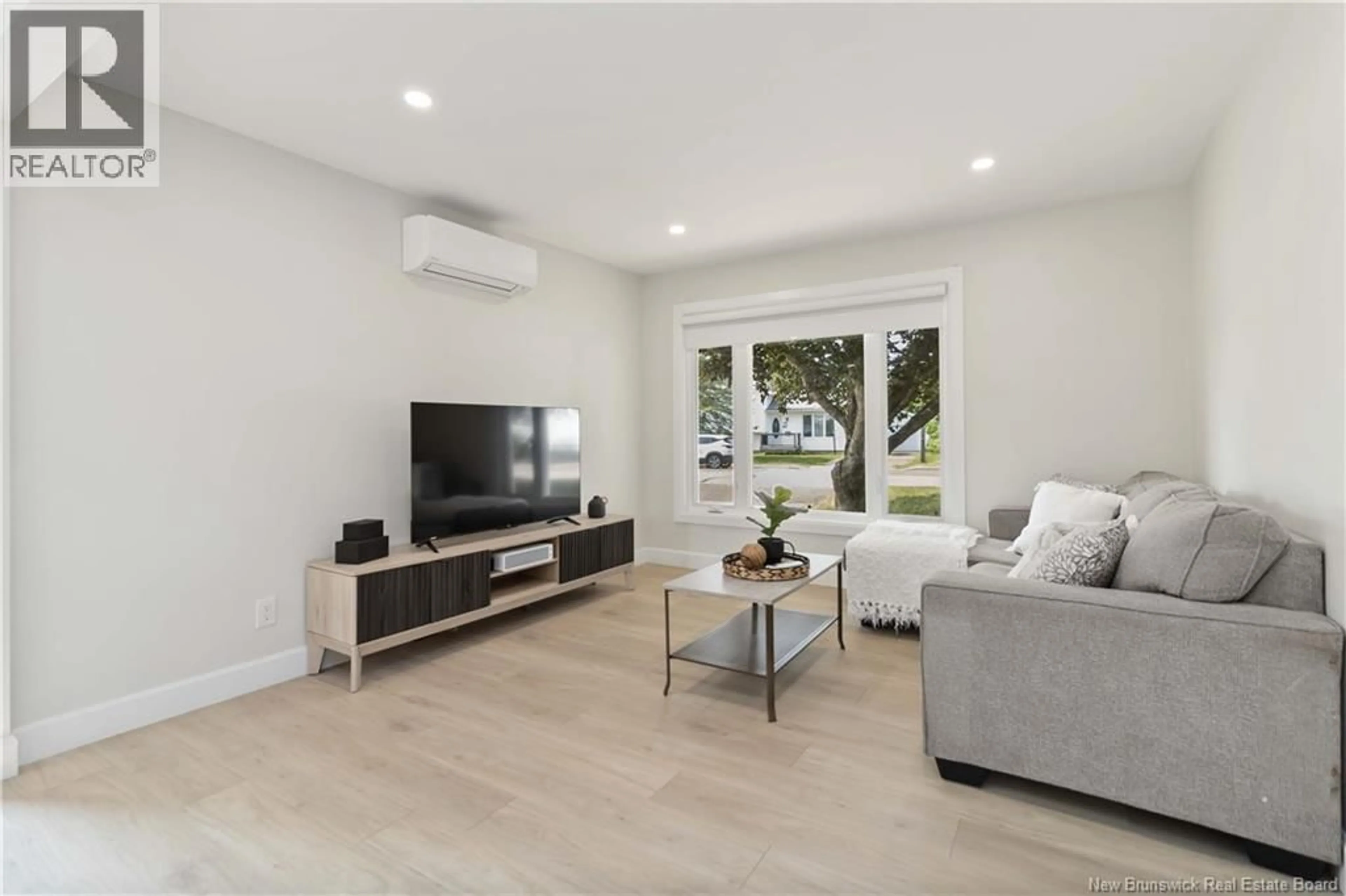 Living room with furniture, wood/laminate floor for 22 WYNWOOD DRIVE, Moncton New Brunswick E1A2M3