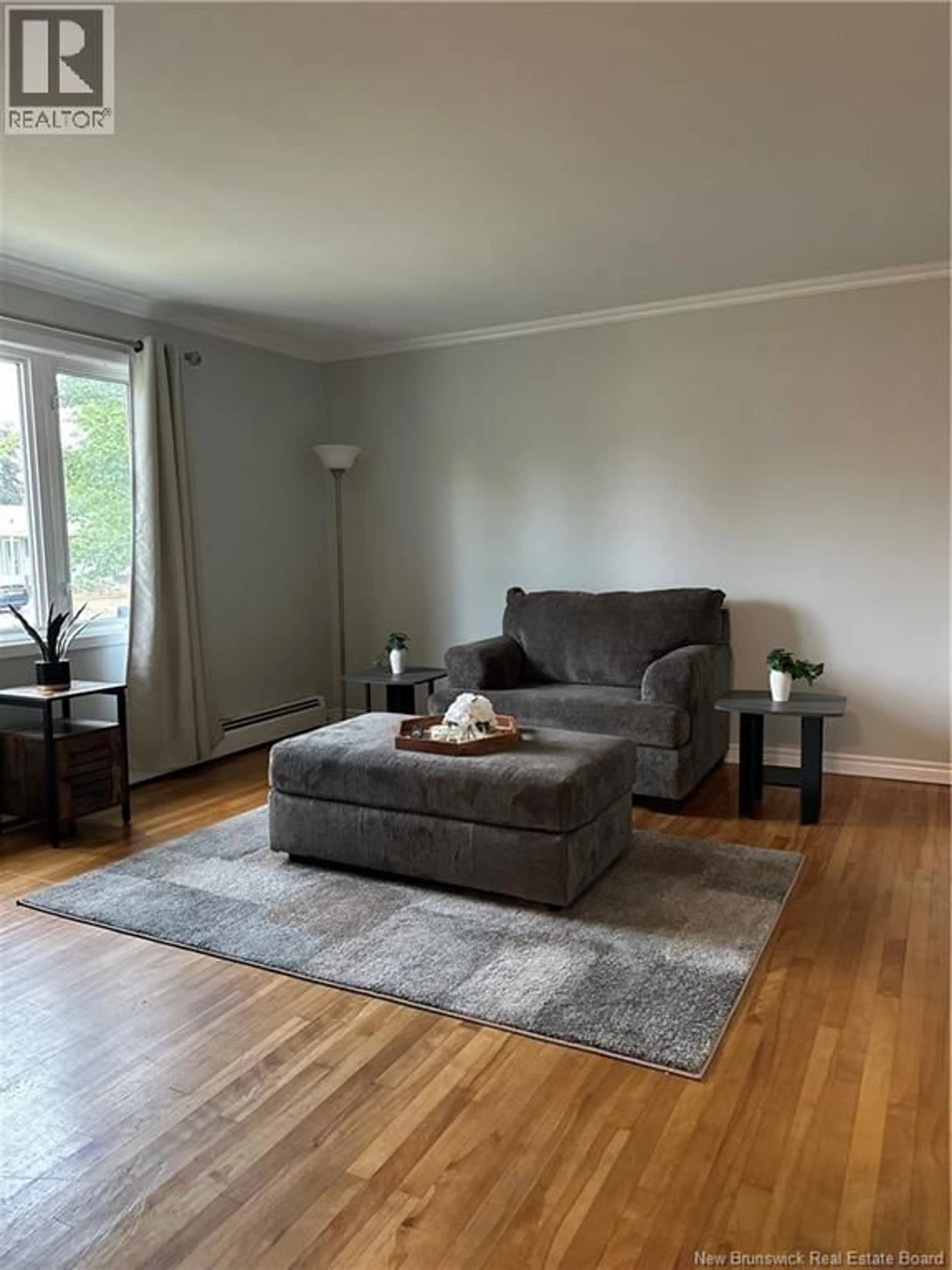 Living room with furniture, wood/laminate floor for 61 ROYAL ROAD, Moncton New Brunswick E1A4S8