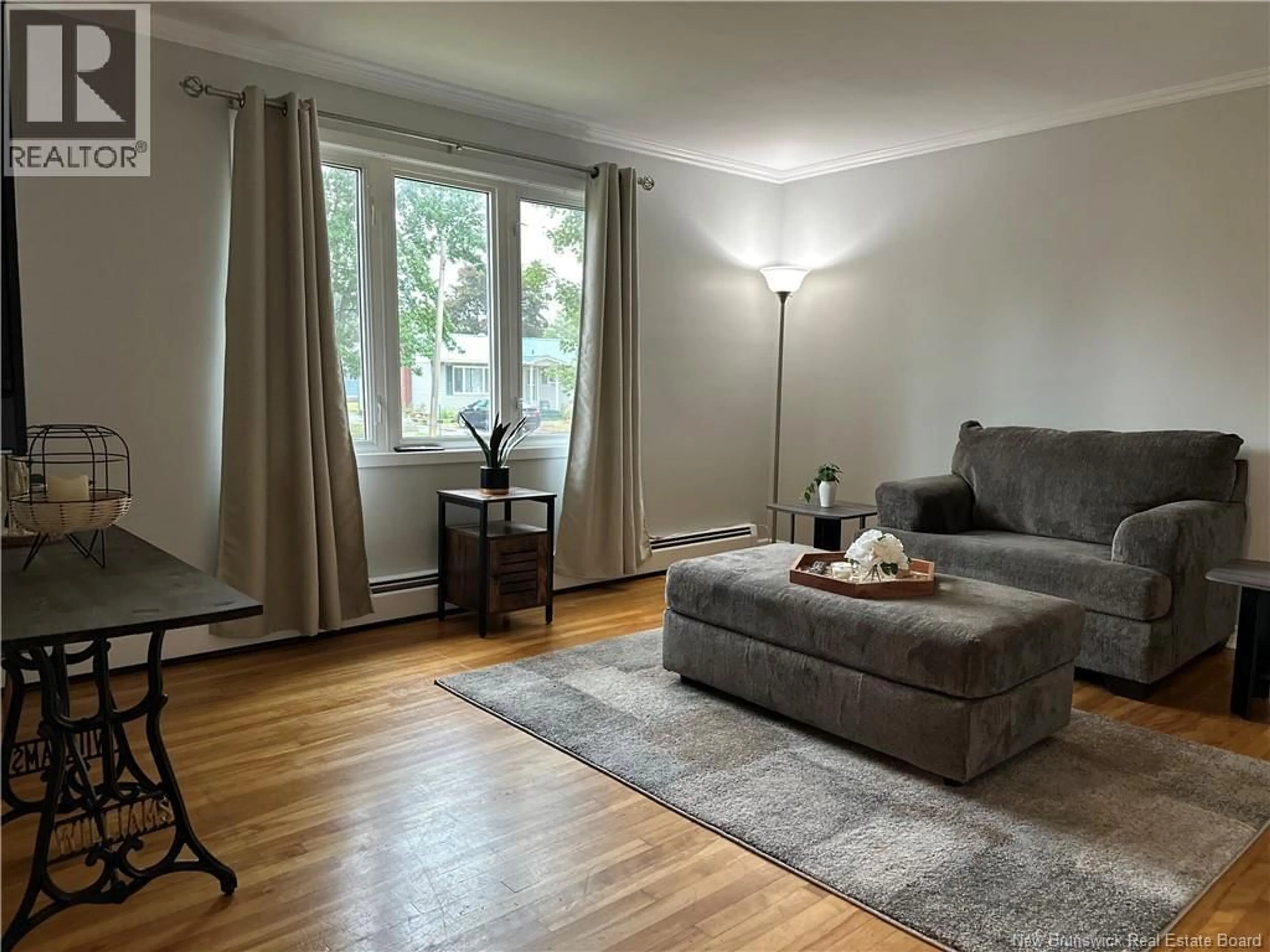 Living room with furniture, wood/laminate floor for 61 ROYAL ROAD, Moncton New Brunswick E1A4S8