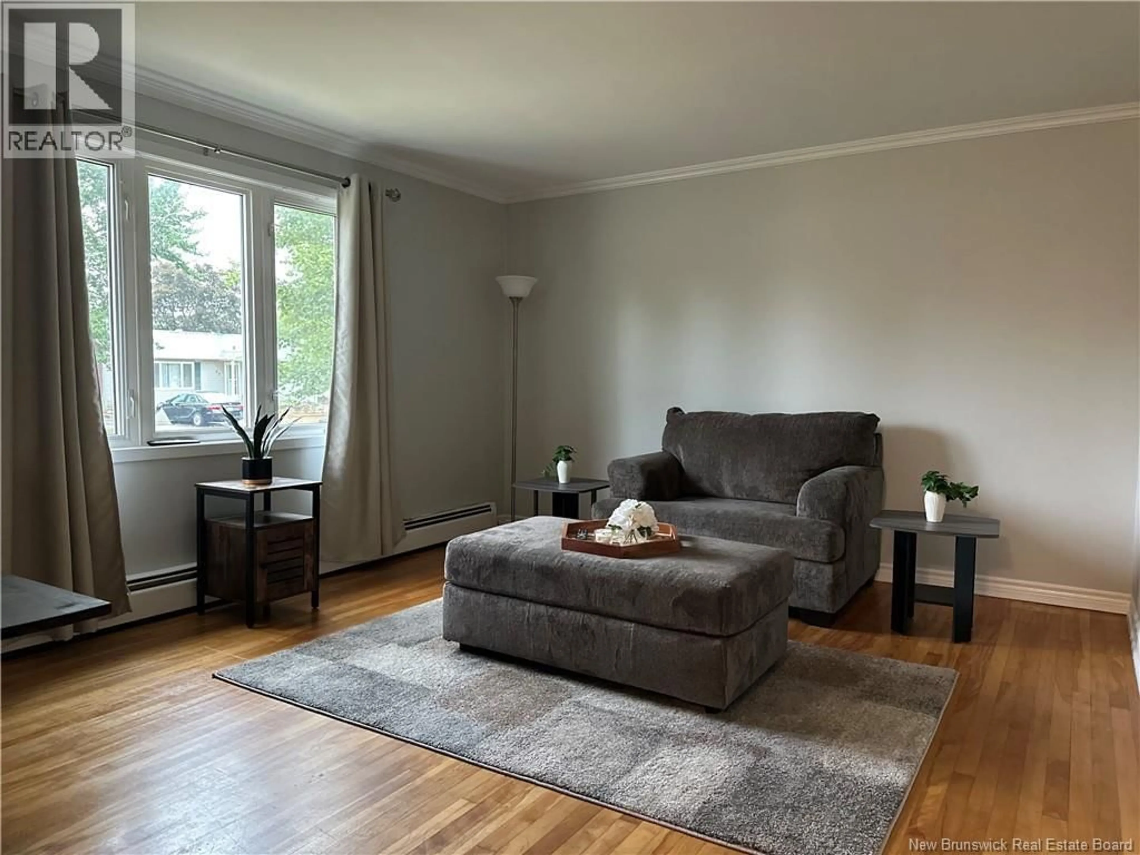 Living room with furniture, wood/laminate floor for 61 ROYAL ROAD, Moncton New Brunswick E1A4S8