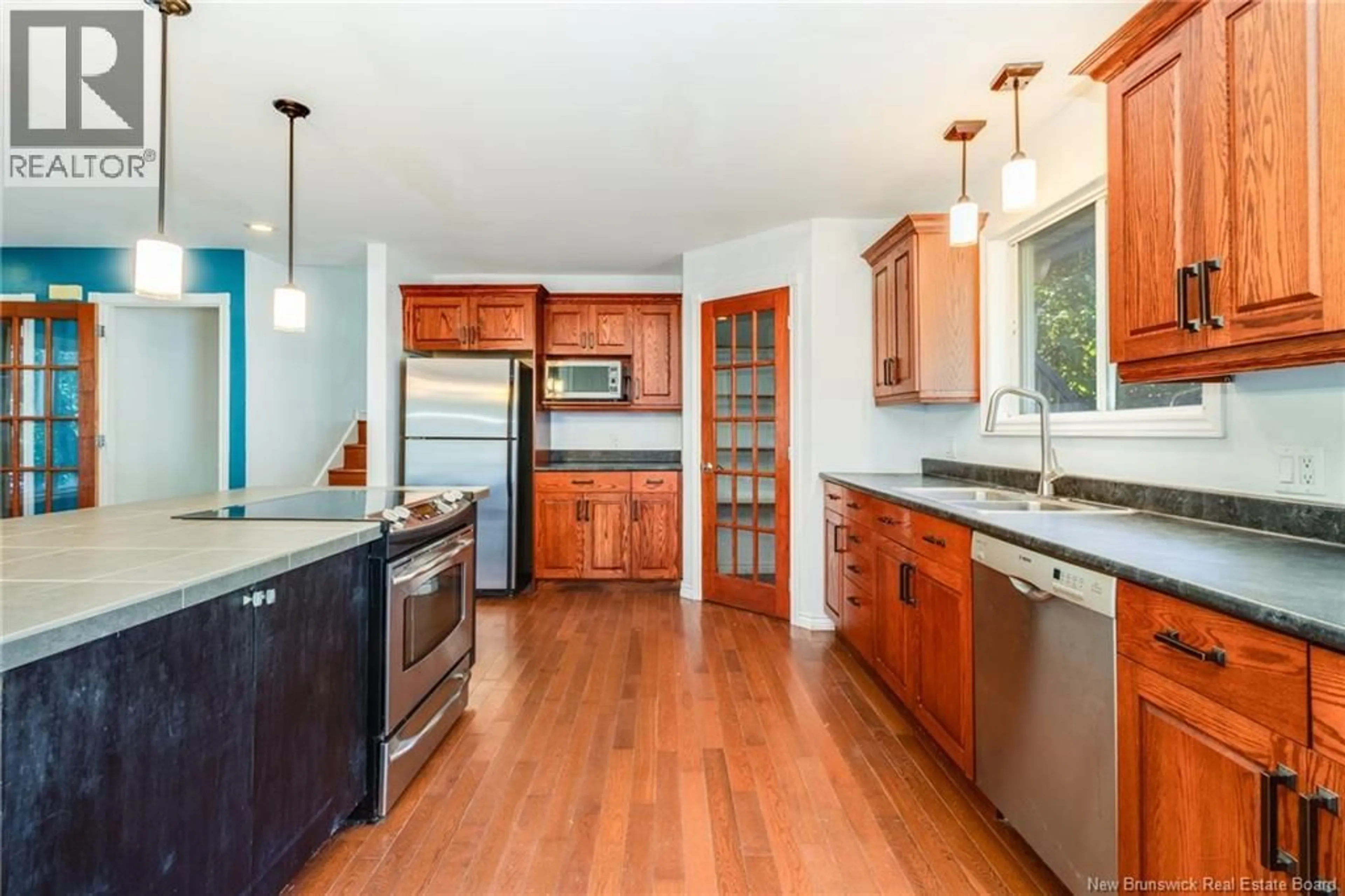 Open concept kitchen, wood/laminate floor for 65 MACINTOSH DRIVE, New Maryland New Brunswick E3C1B5