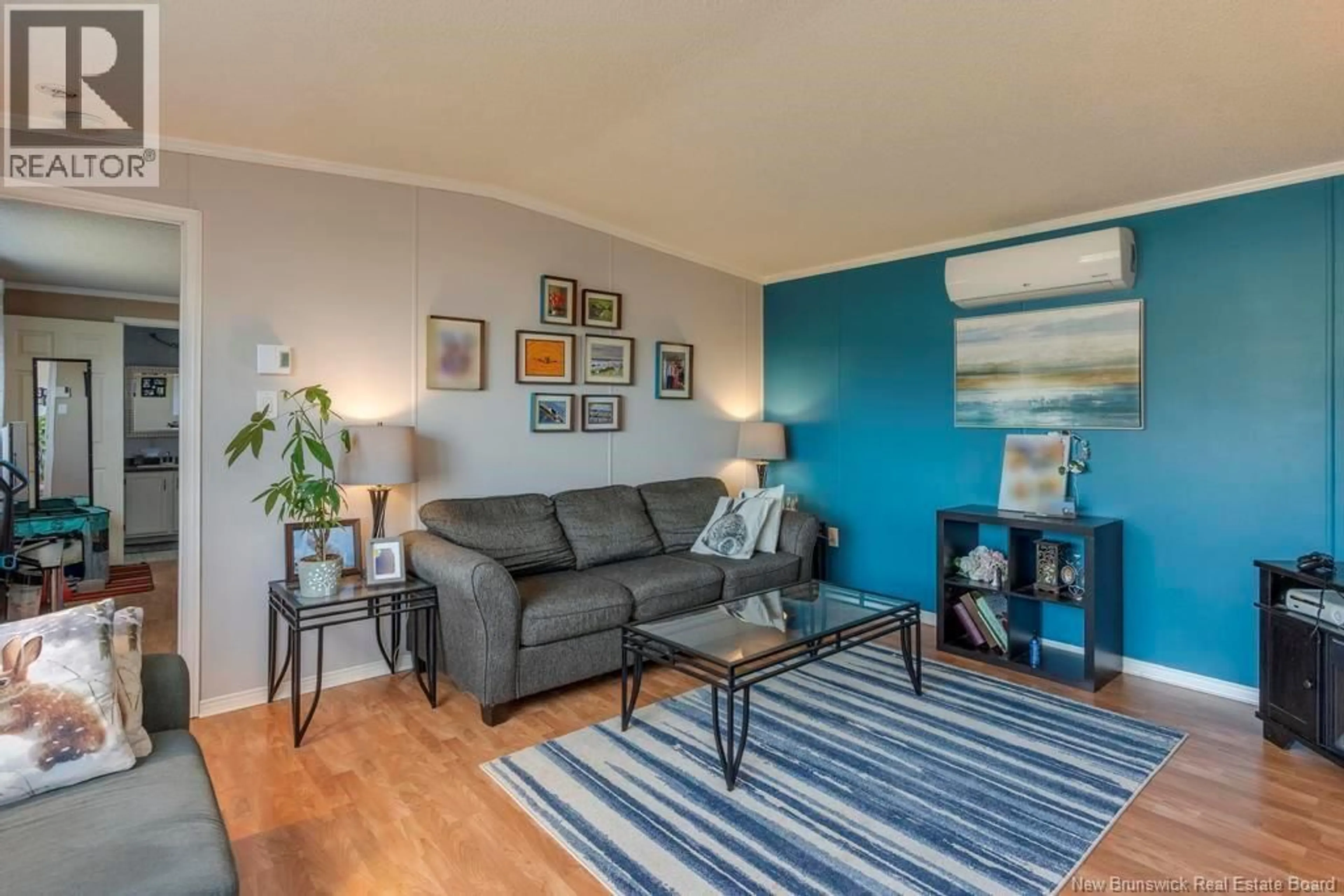 Living room with furniture, wood/laminate floor for 16 RESTIGOUCHE DRIVE, Dieppe New Brunswick E1A7N1