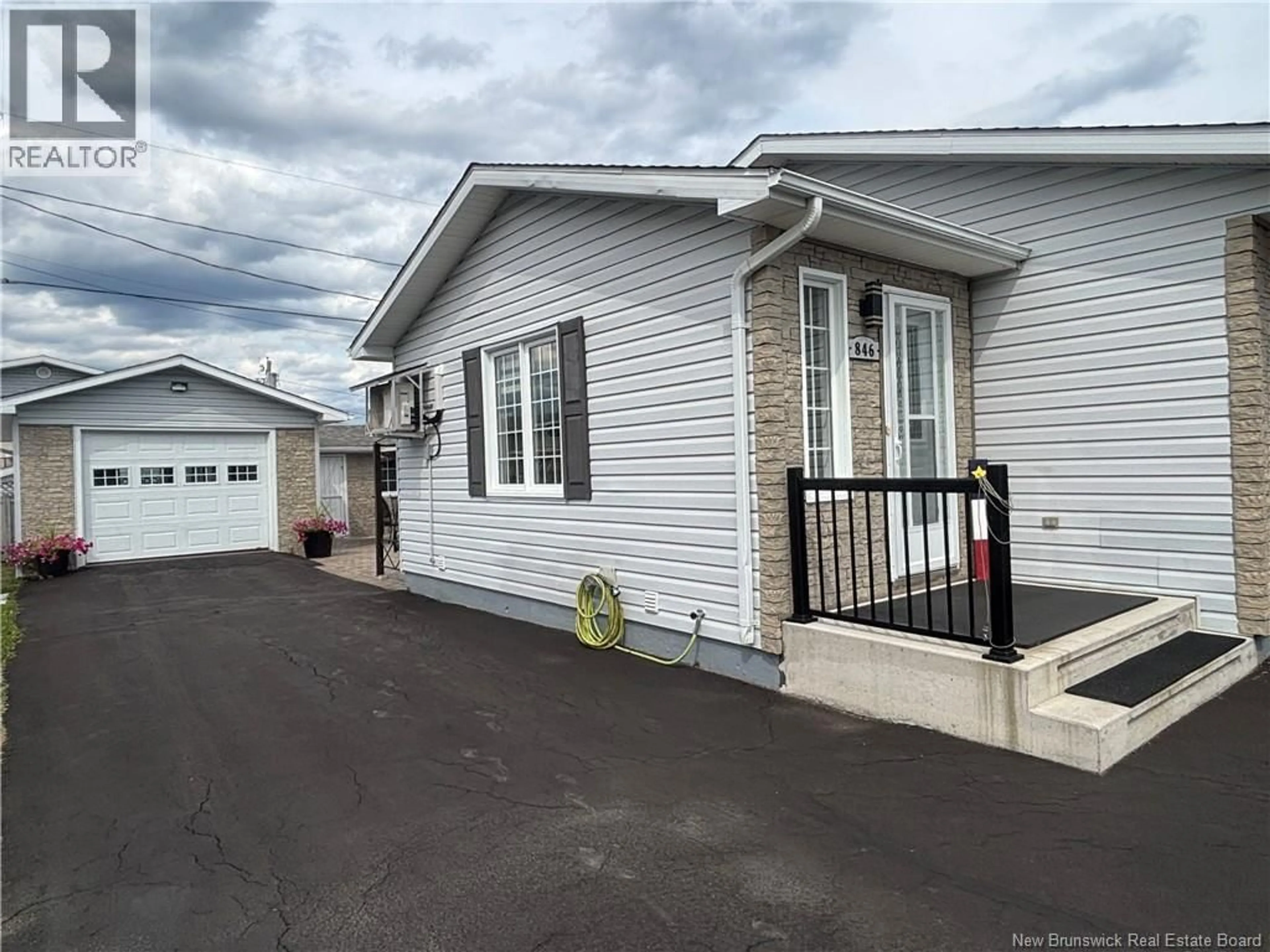 Home with vinyl exterior material, street for 846 RUE ST-PIERRE, Beresford New Brunswick E8K1S2