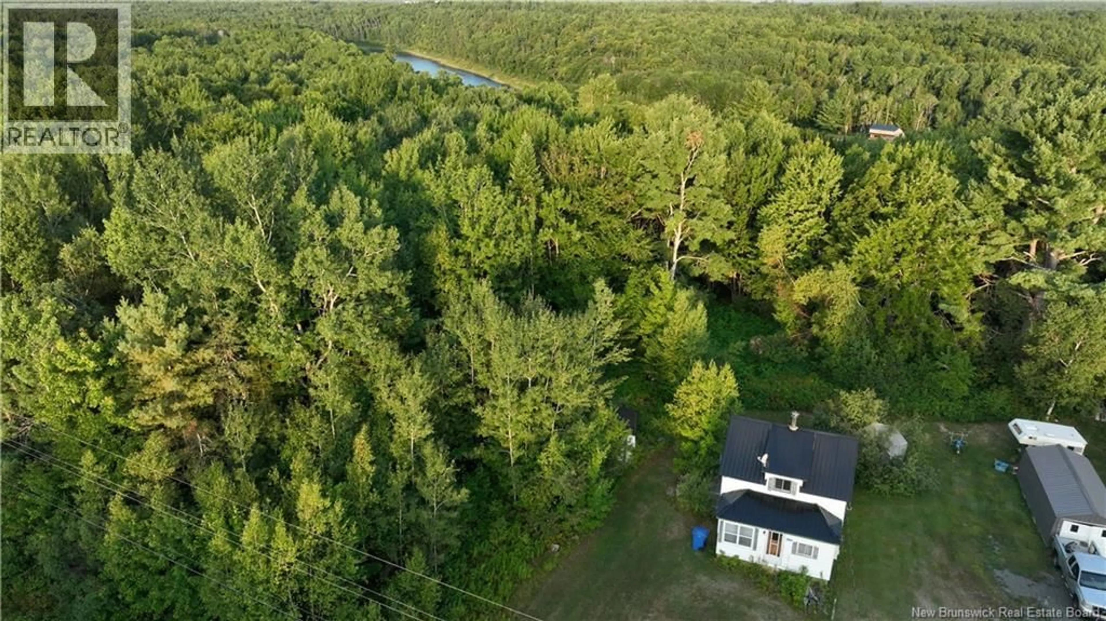 A pic from outside/outdoor area/front of a property/back of a property/a pic from drone, forest/trees view for 1455 HWY 118, White Rapids New Brunswick E9B1A6