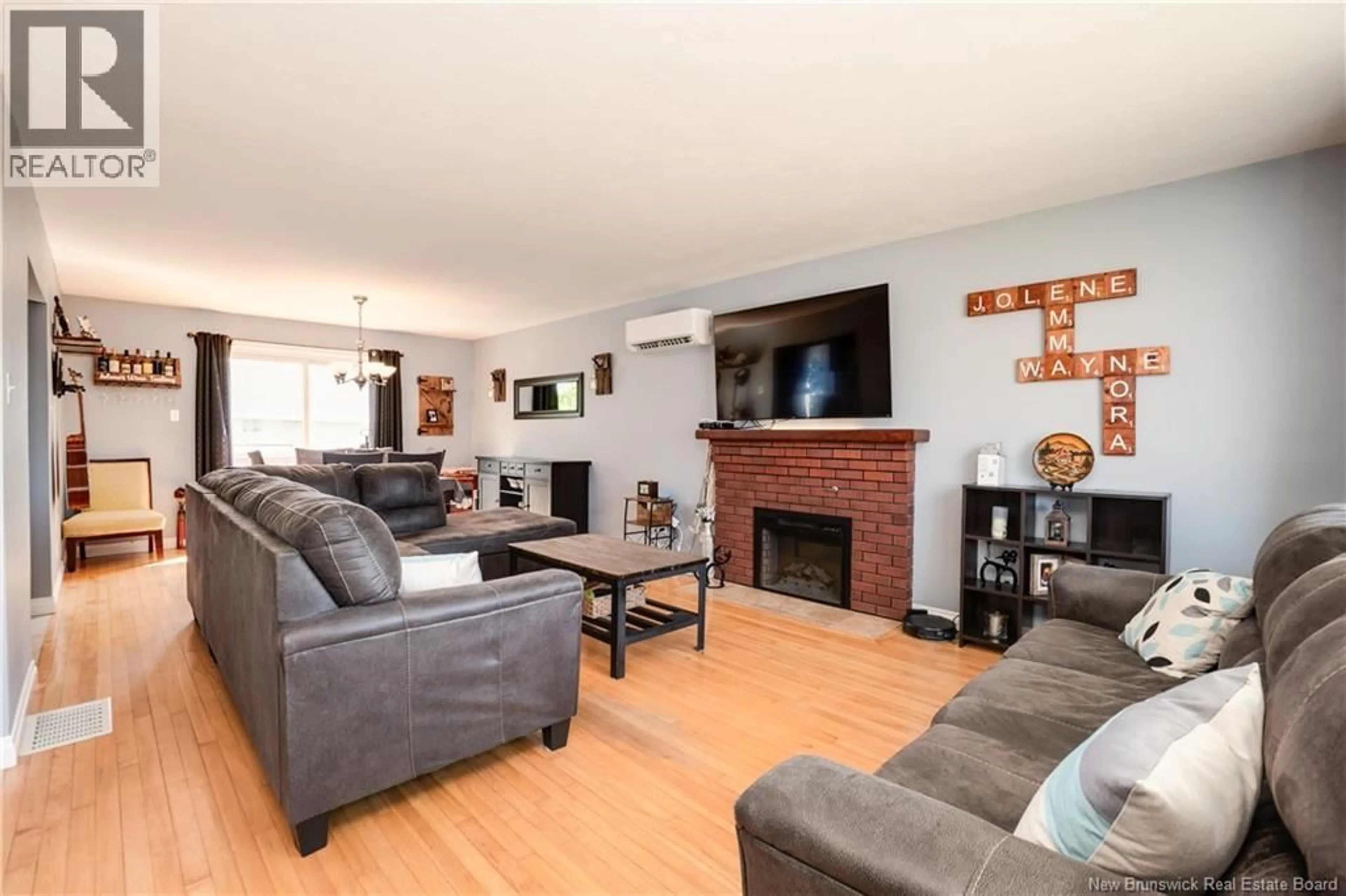 Living room with furniture, wood/laminate floor for 8 COPP STREET, Dieppe New Brunswick E1A2H1