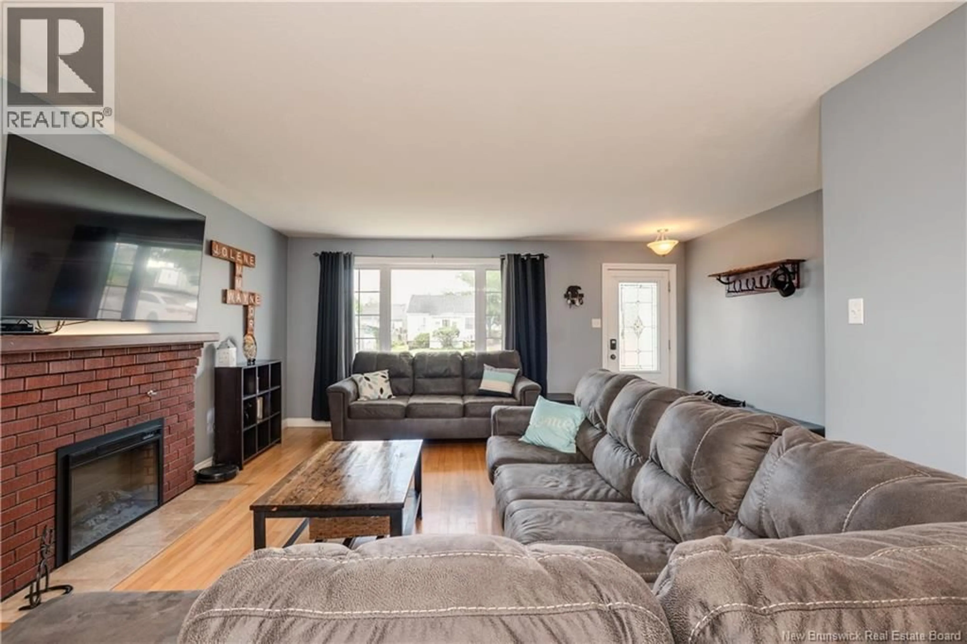 Living room with furniture, wood/laminate floor for 8 COPP STREET, Dieppe New Brunswick E1A2H1