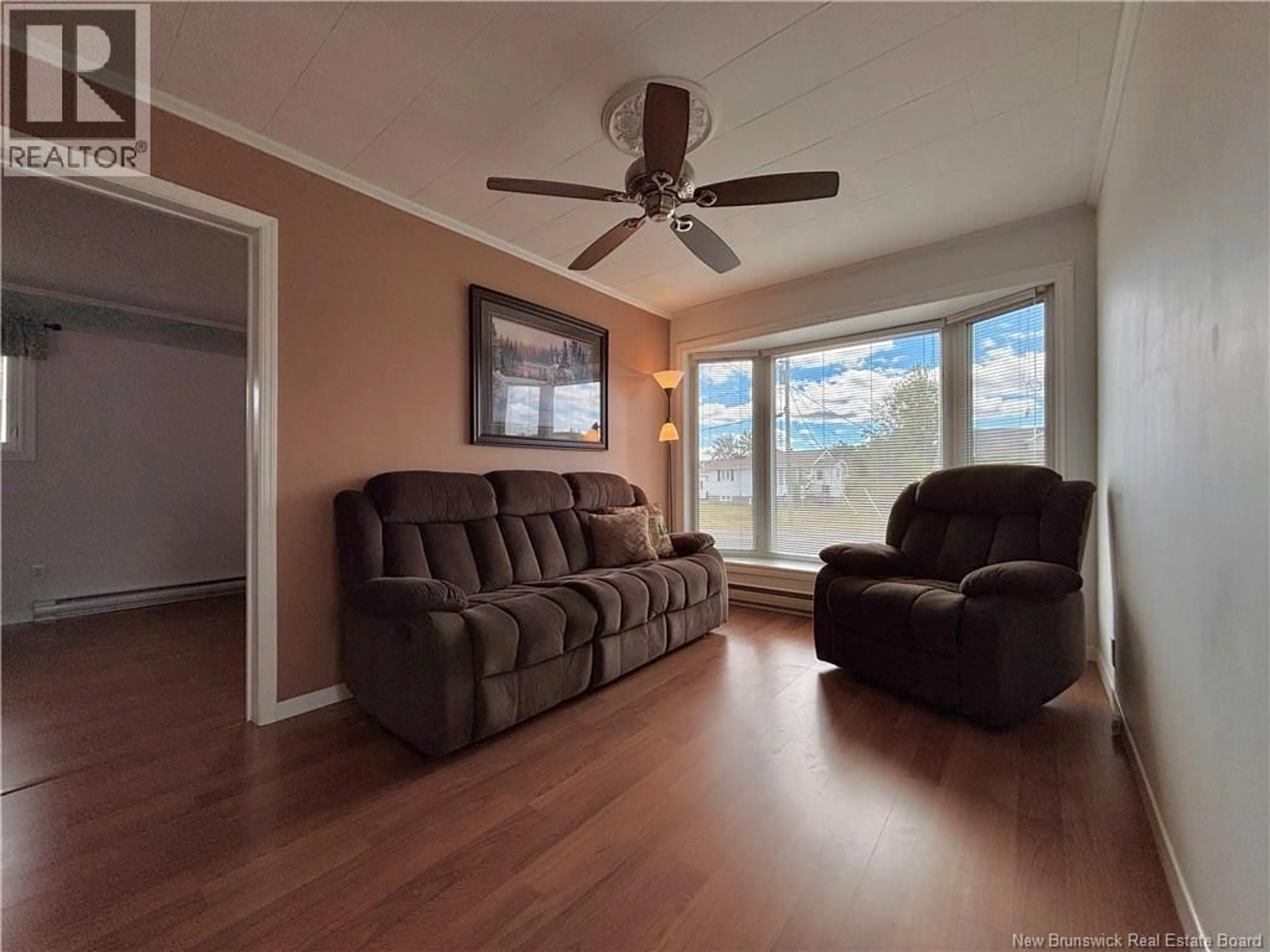 Living room with furniture, wood/laminate floor for 250 GODIN, Beresford New Brunswick E8K1T7