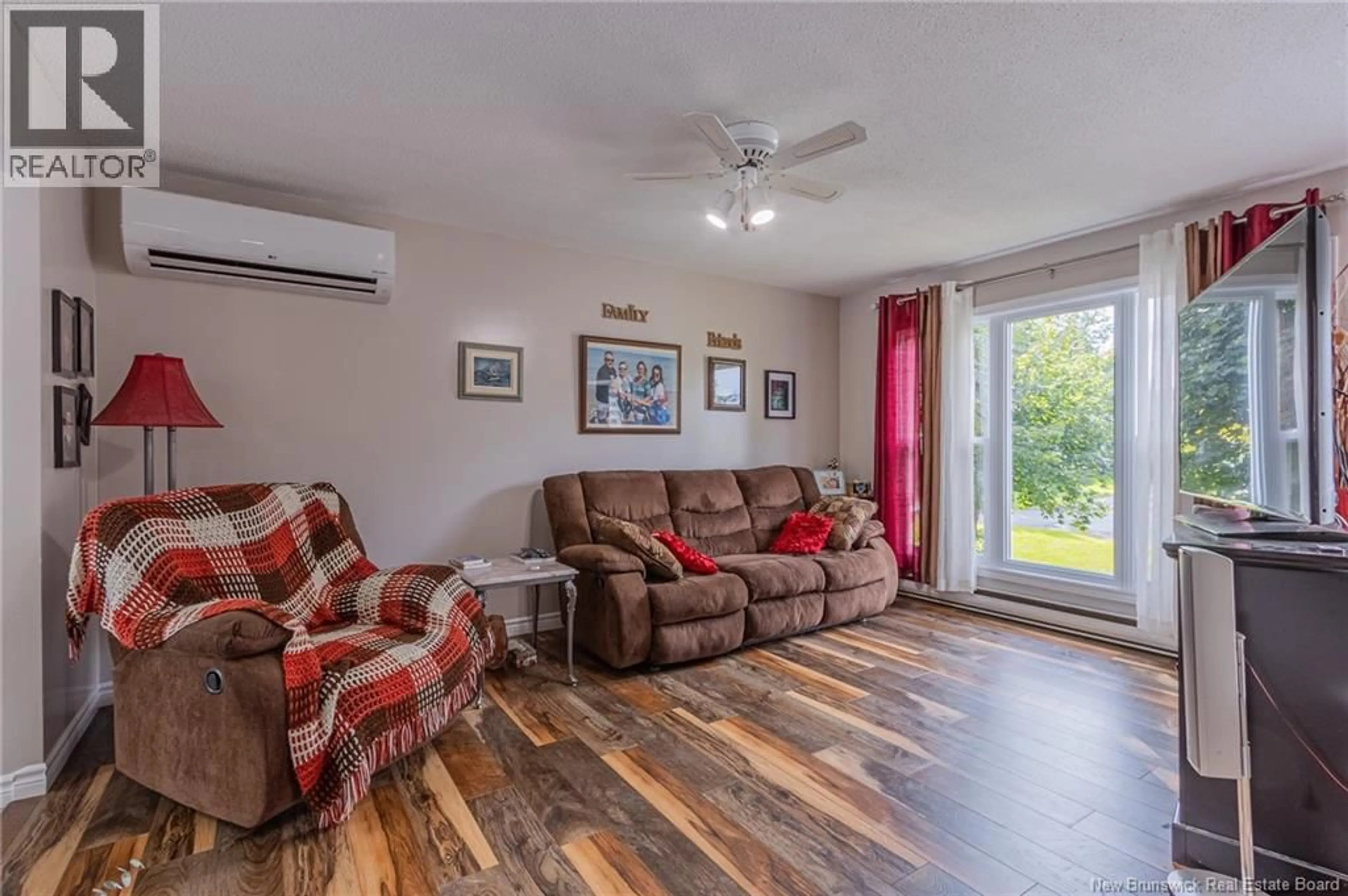 Living room with furniture, wood/laminate floor for 214 MAURICE CRESCENT, Beresford New Brunswick E8K1L4
