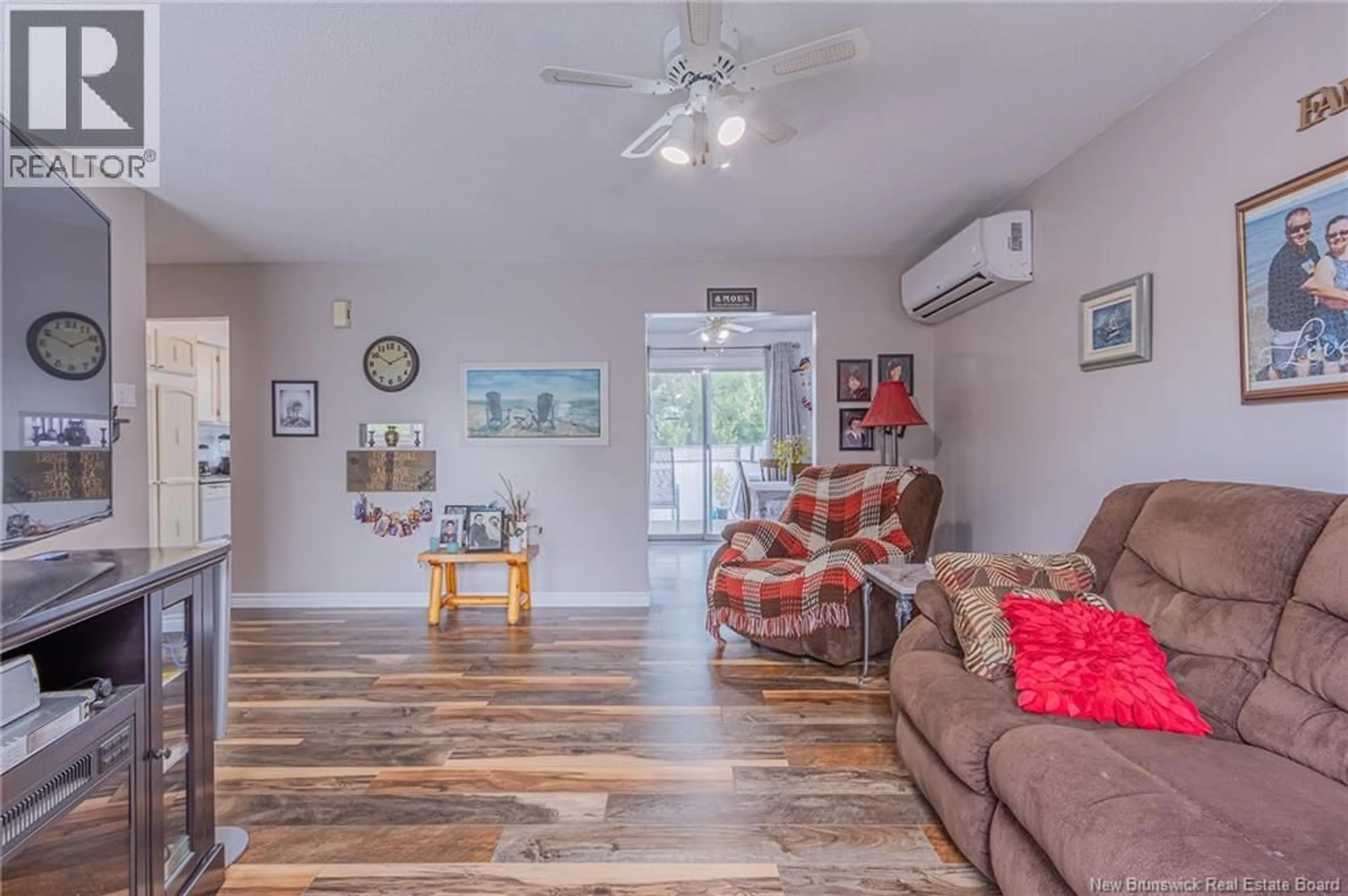 Living room with furniture, wood/laminate floor for 214 MAURICE CRESCENT, Beresford New Brunswick E8K1L4