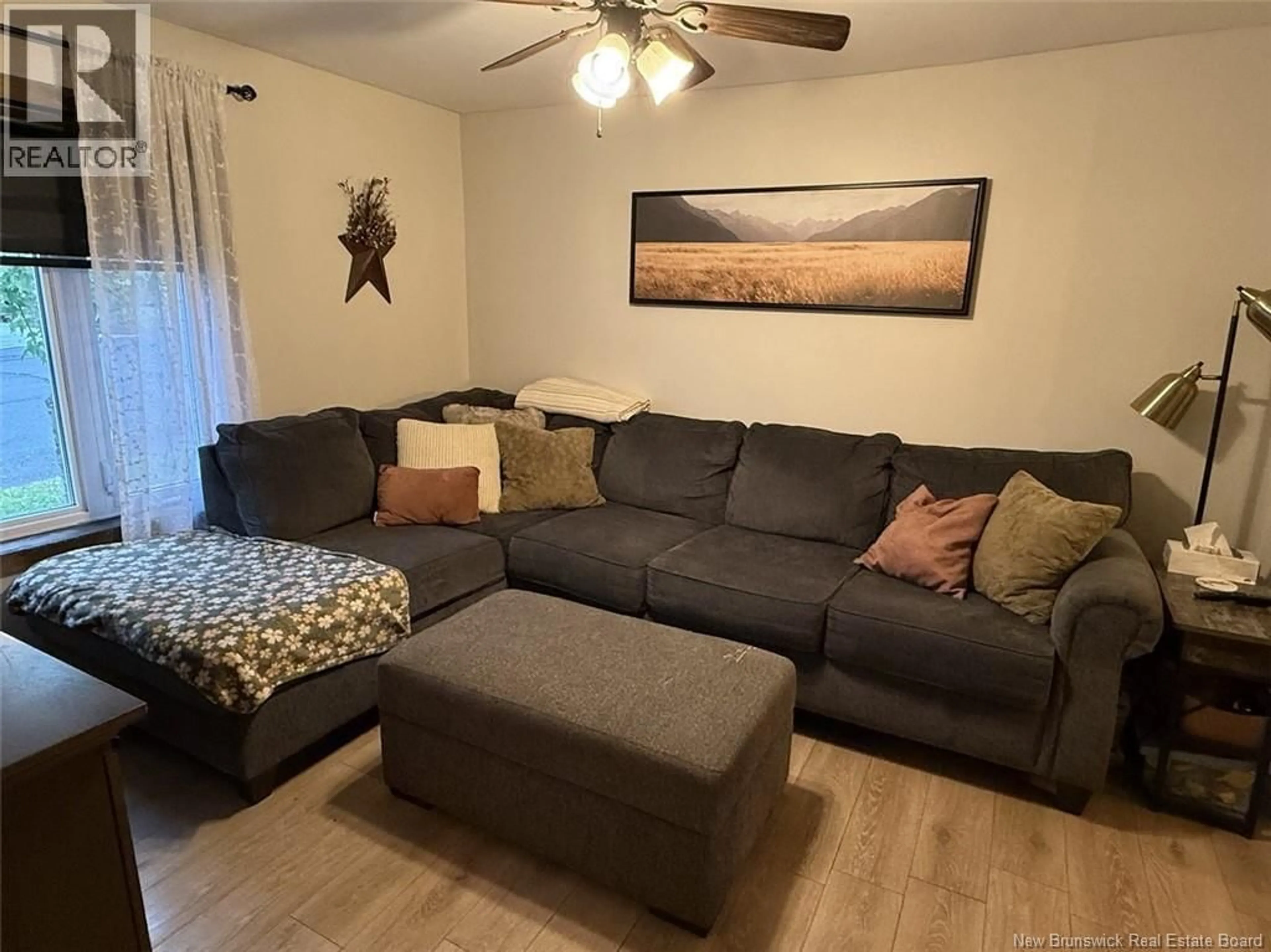 Living room with furniture, wood/laminate floor for 75 35TH AVENUE, Edmundston New Brunswick E3V2V1