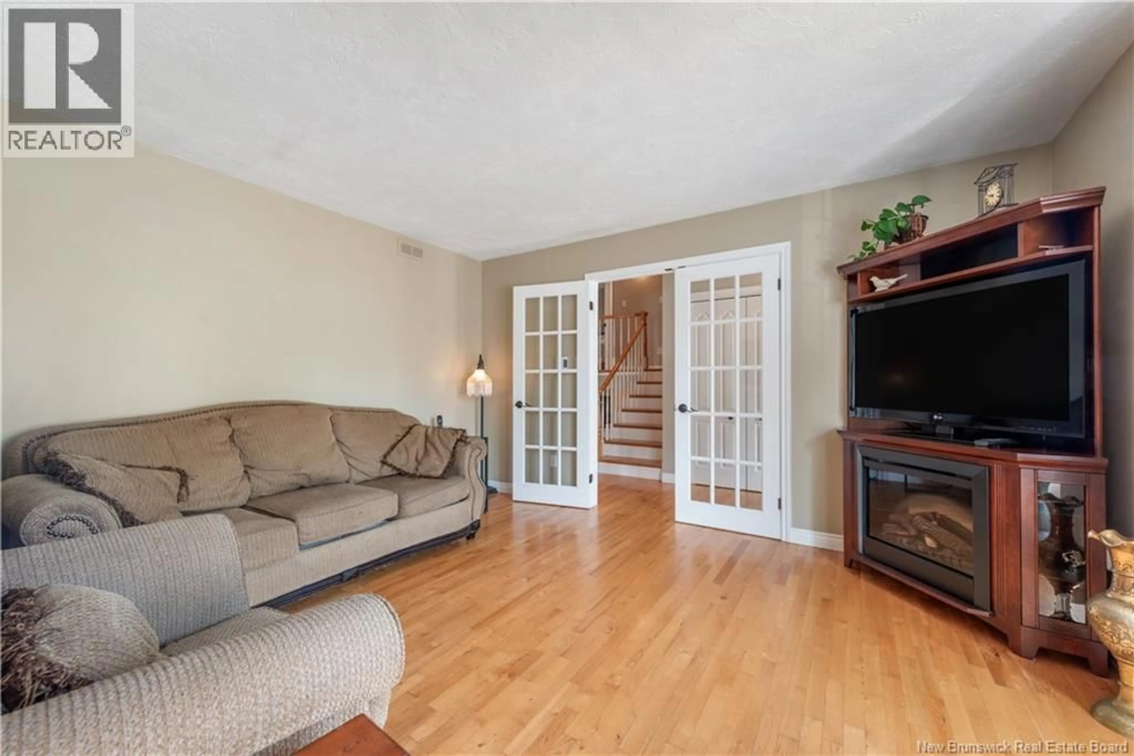 Living room with furniture, wood/laminate floor for 153 ELMHURST, Moncton New Brunswick E1C9V4