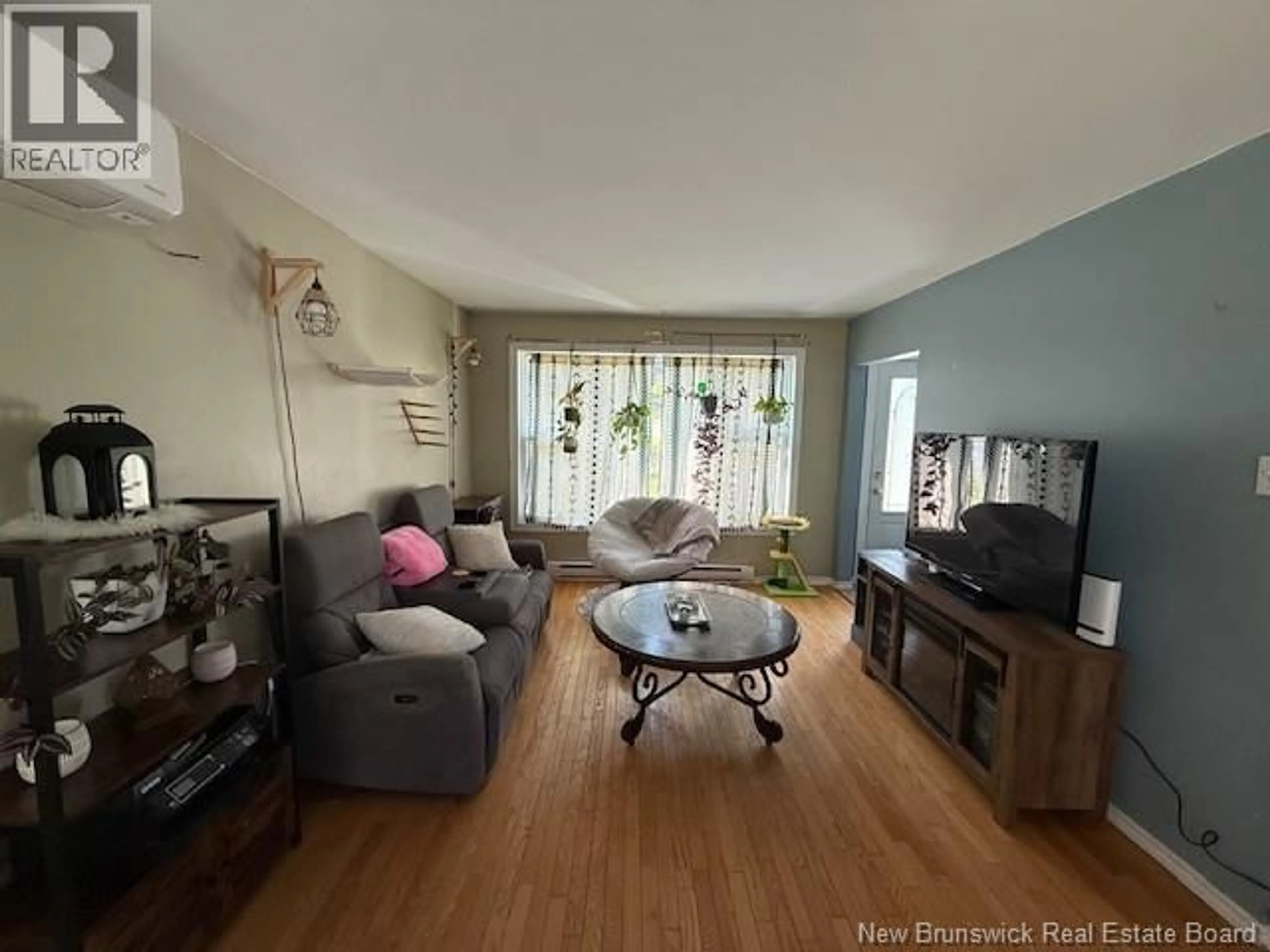 Living room with furniture, wood/laminate floor for 497 CAMERON STREET, Dalhousie New Brunswick E8C1J5
