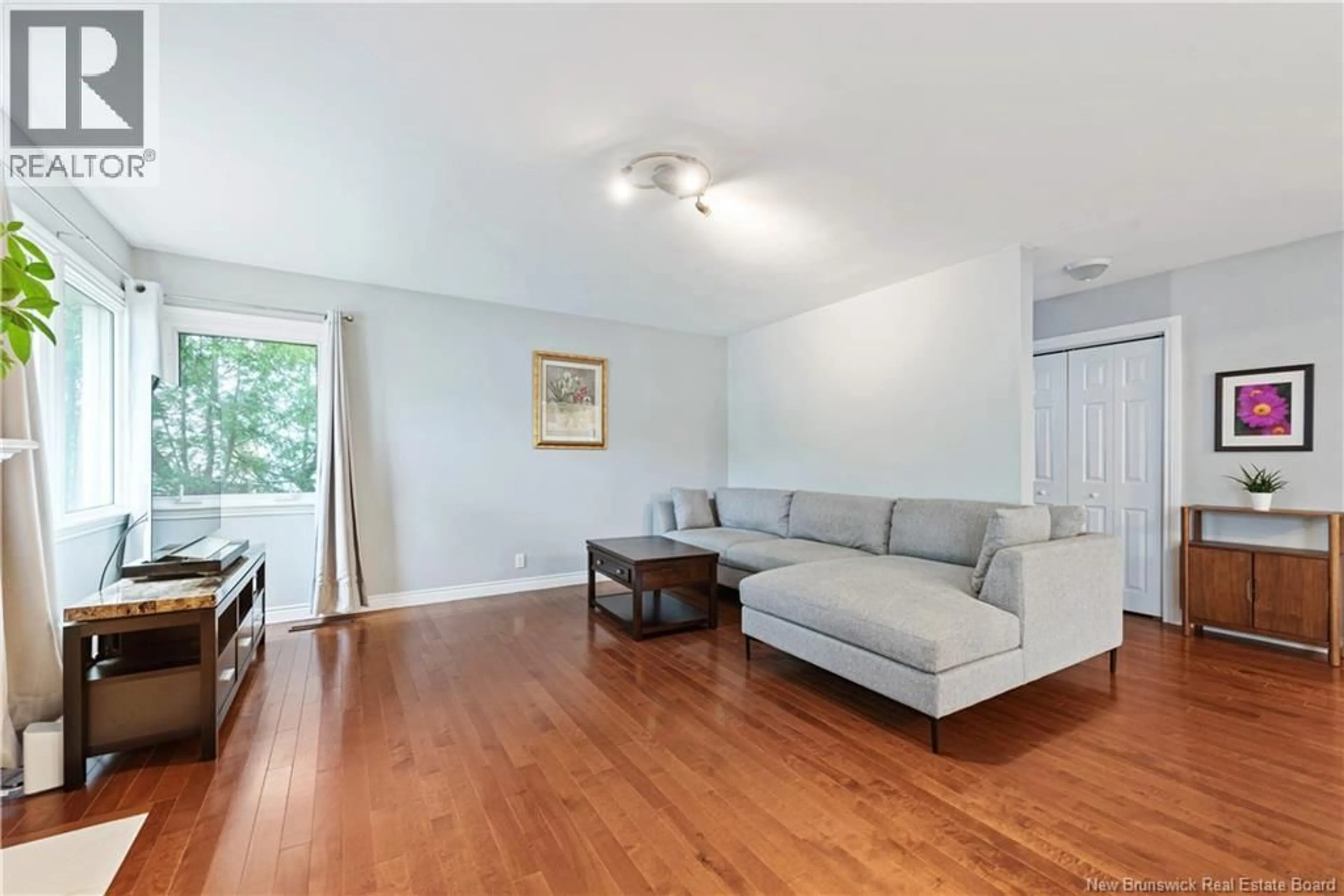 Living room with furniture, wood/laminate floor for 21 READE STREET, Moncton New Brunswick E1C6S1